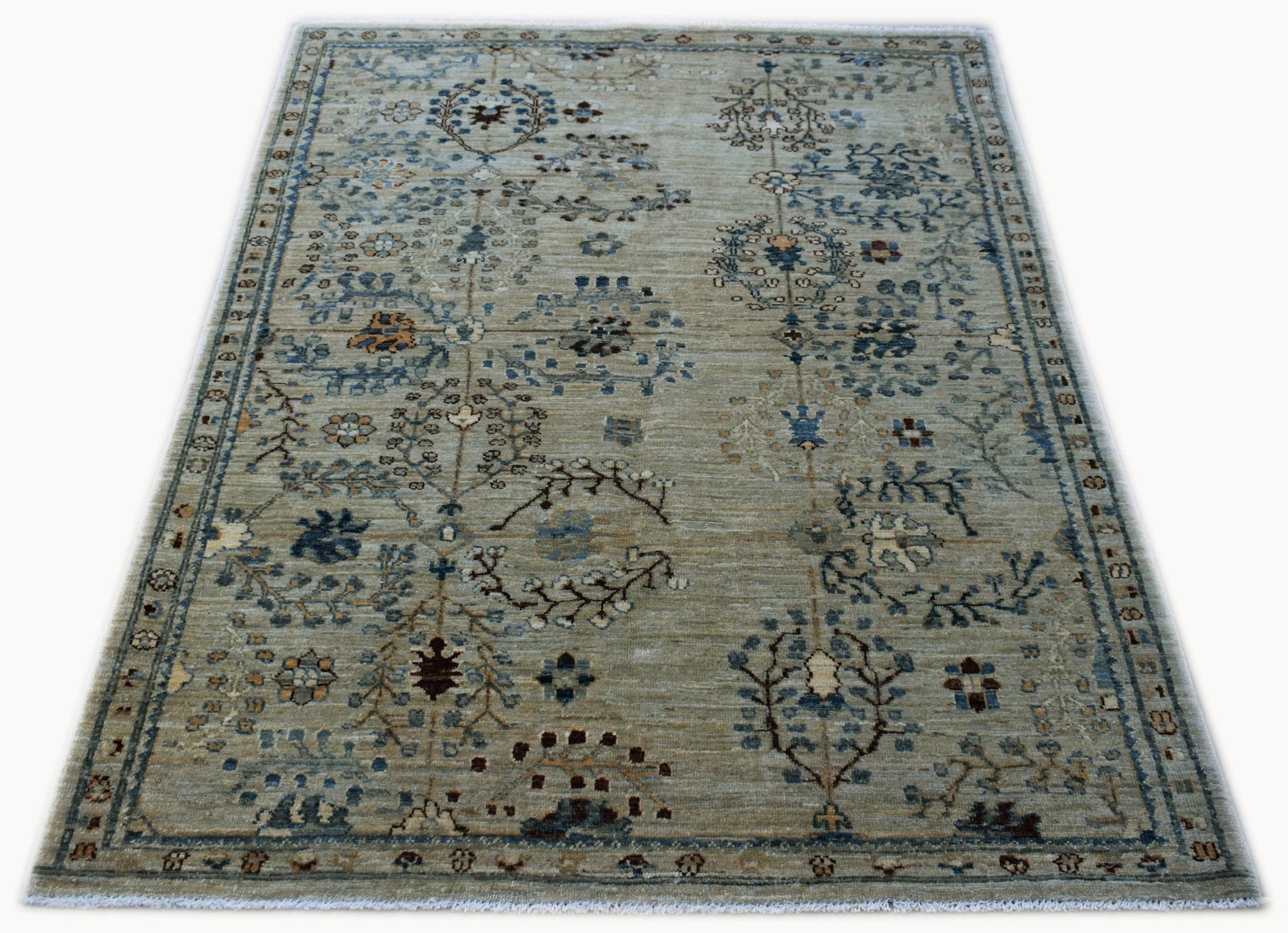 Handwoven Afghan Chobi rug featuring a traditional floral pattern in muted earth tones.