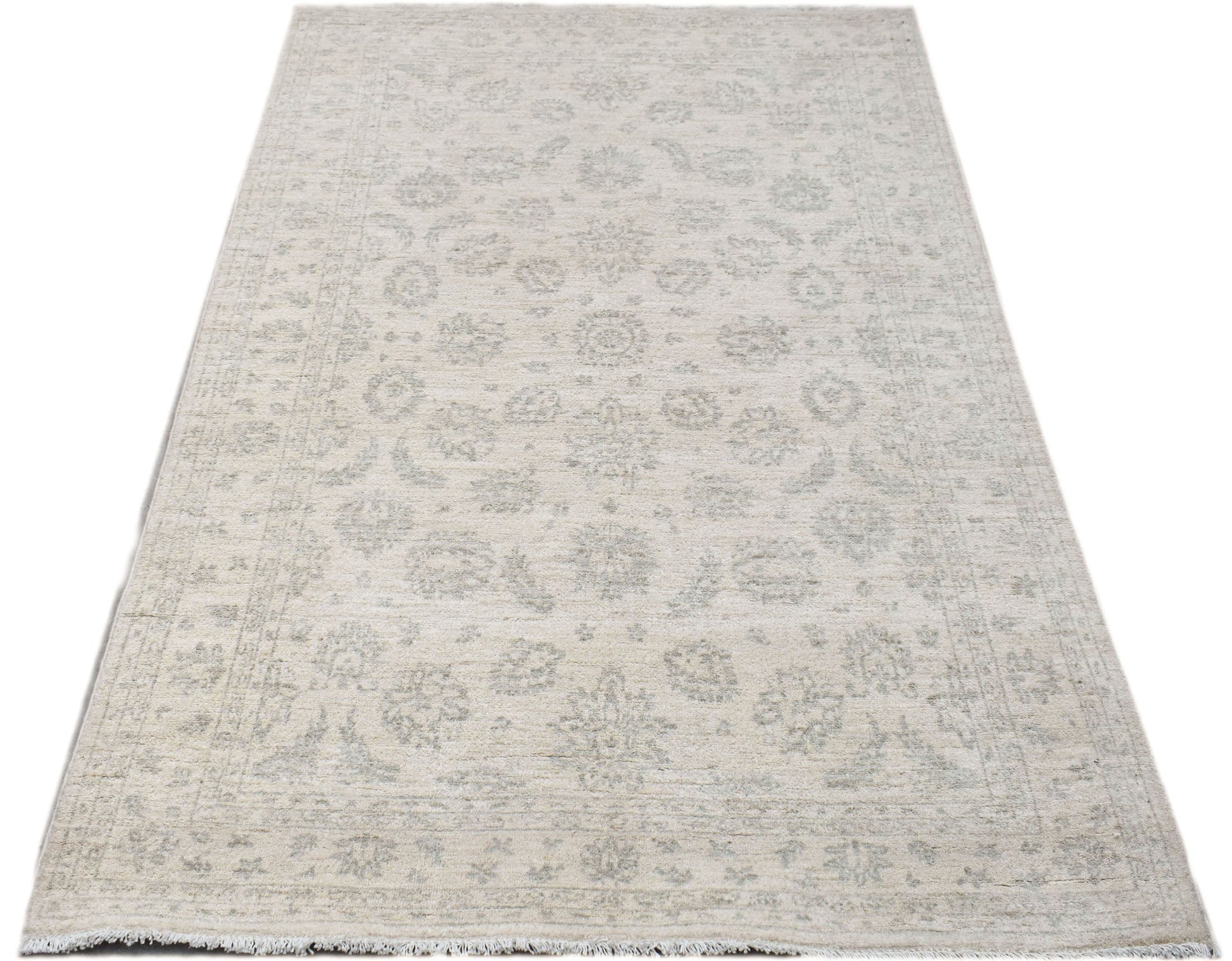 Handwoven Afghan Chobi rug featuring a traditional floral pattern in soft beige and grey tones.