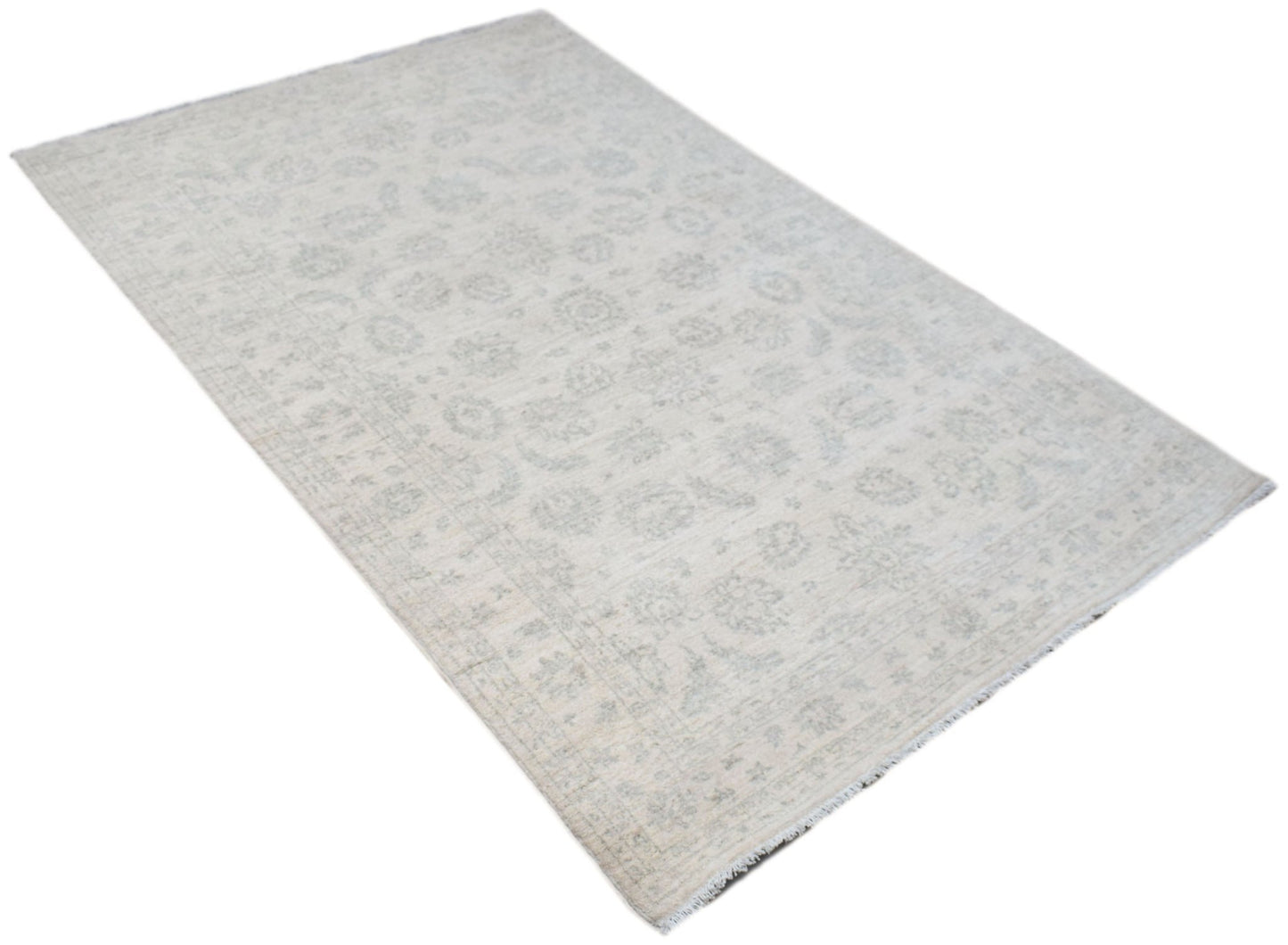 An Afghan Chobi rug featuring a subtle, light-toned floral pattern on a handwoven wool pile.