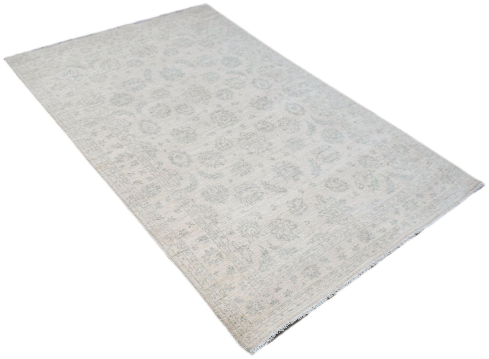 An Afghan Chobi rug featuring a subtle, light-toned floral pattern on a handwoven wool pile.