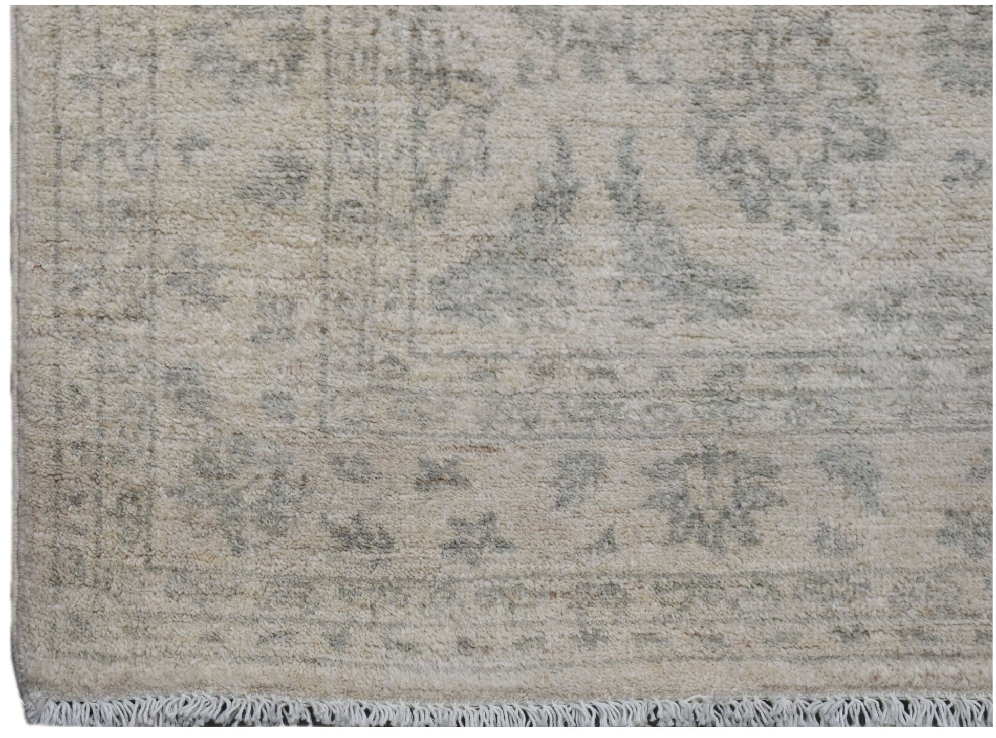 A handmade Afghan Chobi rug featuring a traditional floral pattern in soft beige and grey tones.