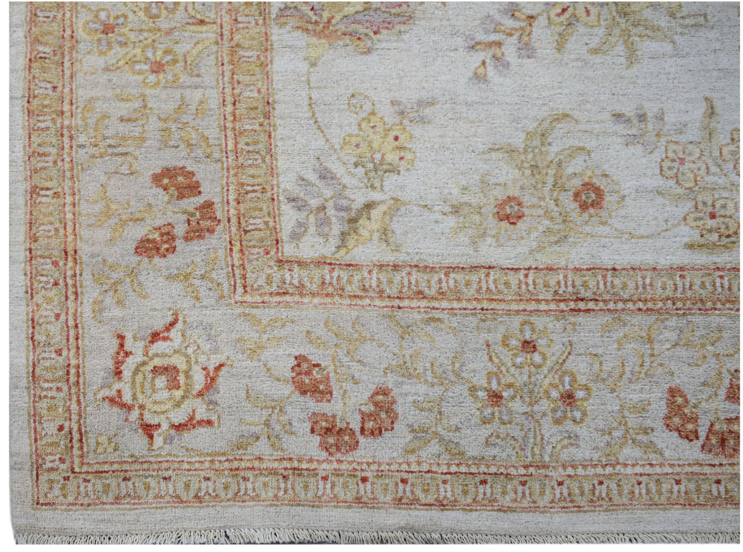 A handmade Afghan Chobi rug featuring a traditional floral pattern in soft earth tones.