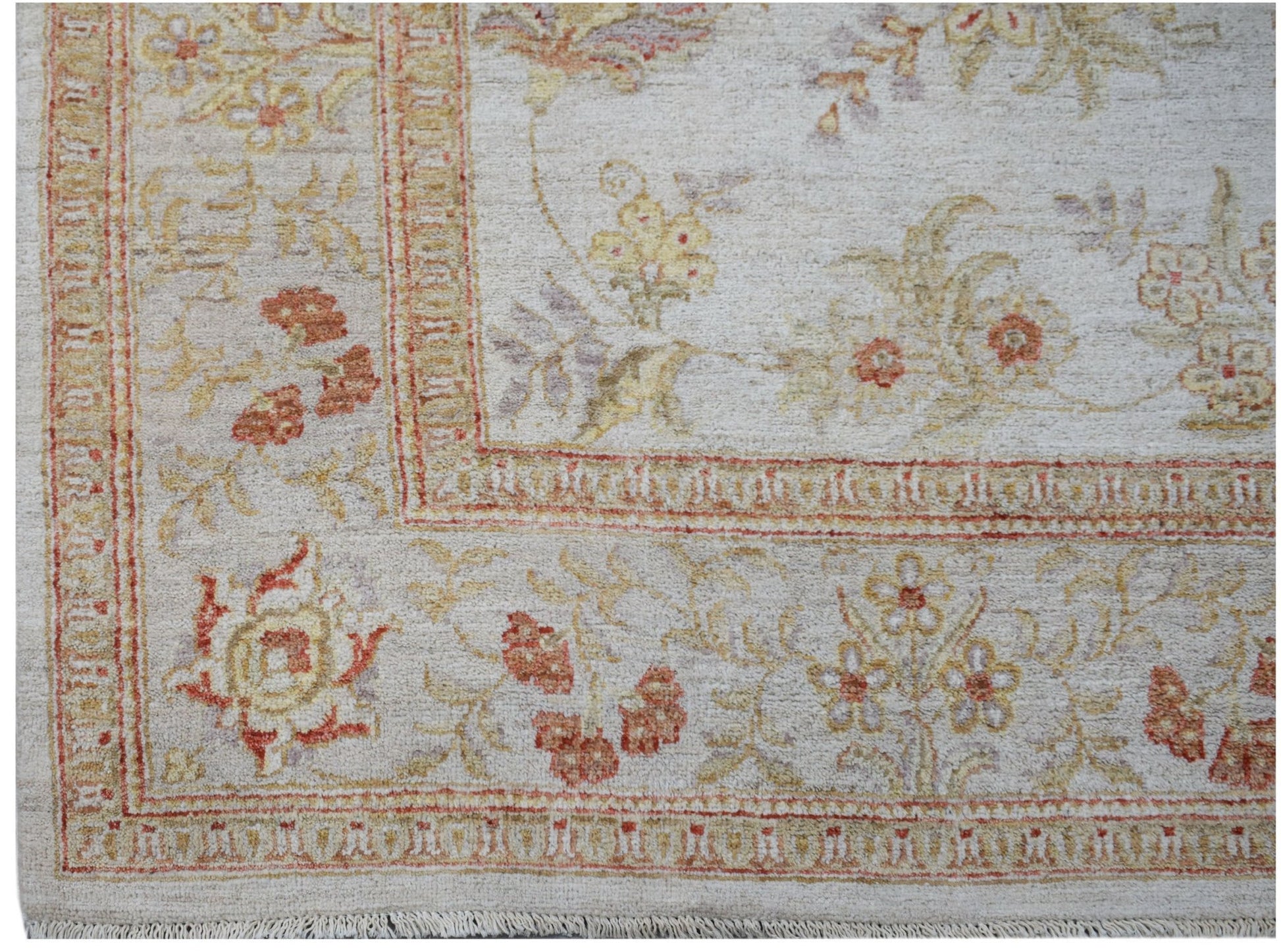 A handmade Afghan Chobi rug featuring a traditional floral pattern in soft earth tones.