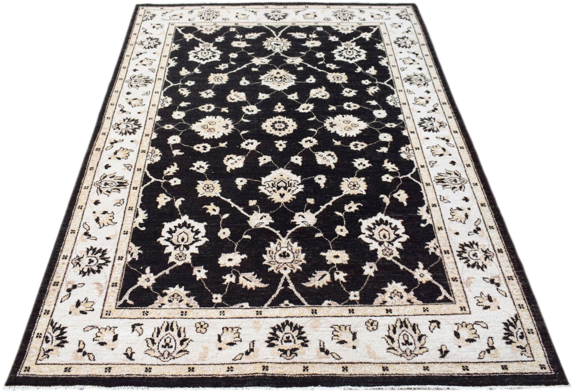 A rectangular Afghan Chobi rug featuring a black field with intricate cream floral patterns.