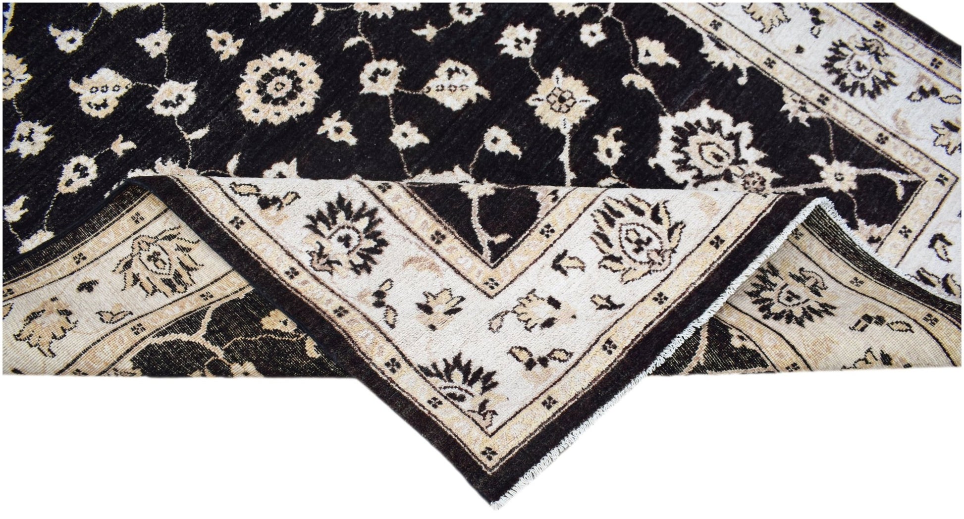 A handwoven Afghan Chobi rug featuring a black field with cream floral patterns and a wide border.