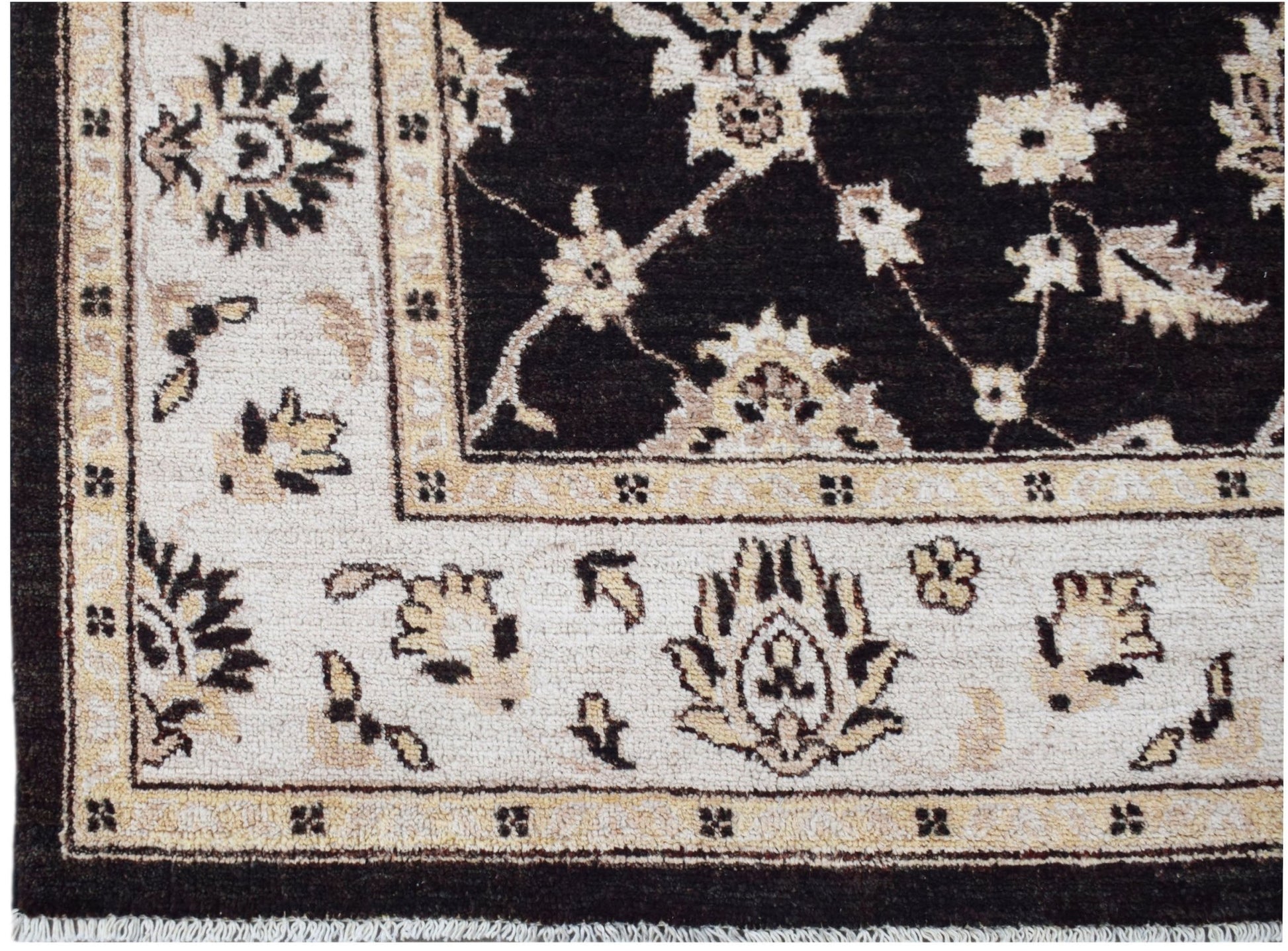 A handmade Afghan Chobi rug featuring a dark brown field with cream floral patterns and borders.