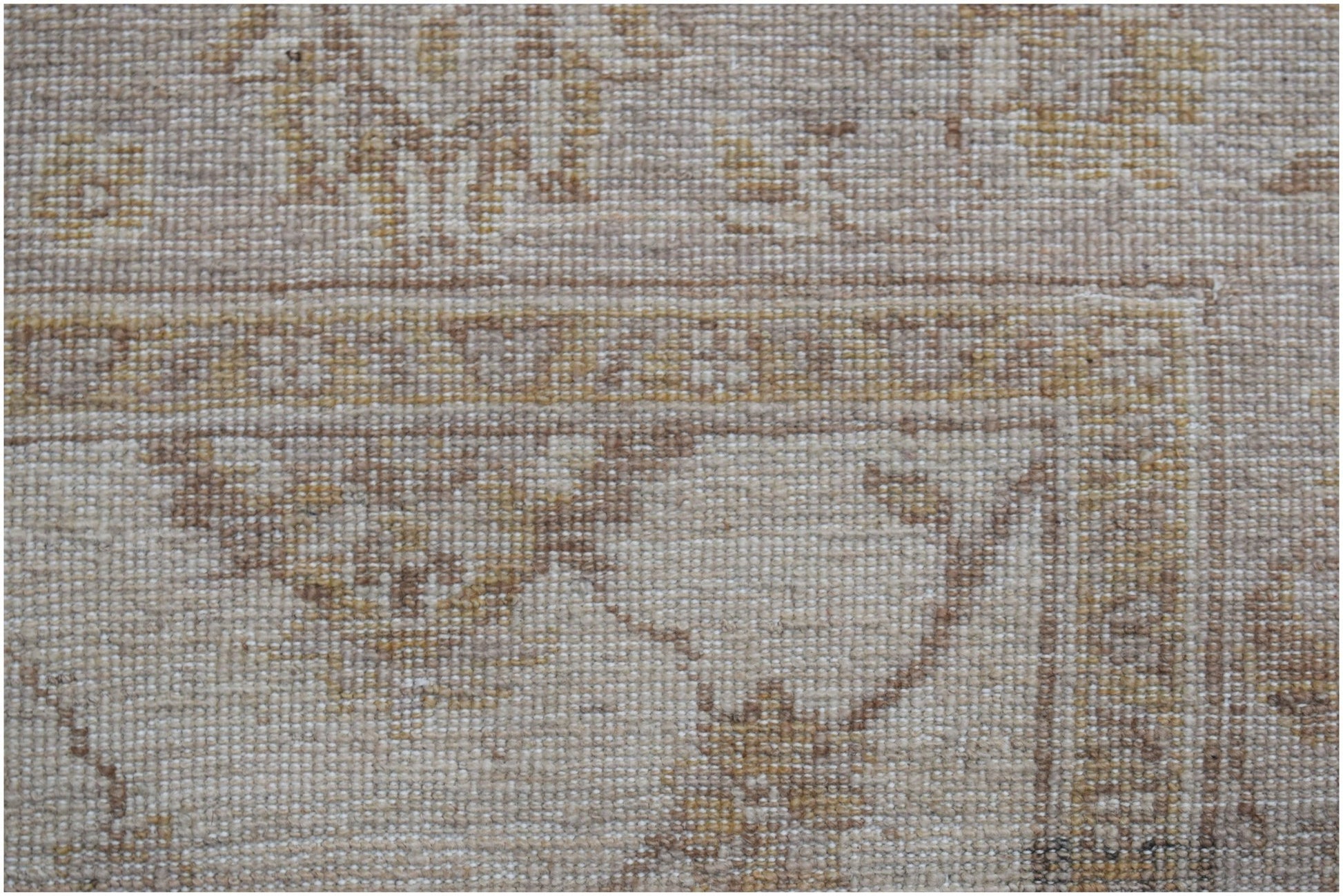 A close-up of a handwoven Afghan Chobi rug featuring traditional patterns in neutral wood tones.