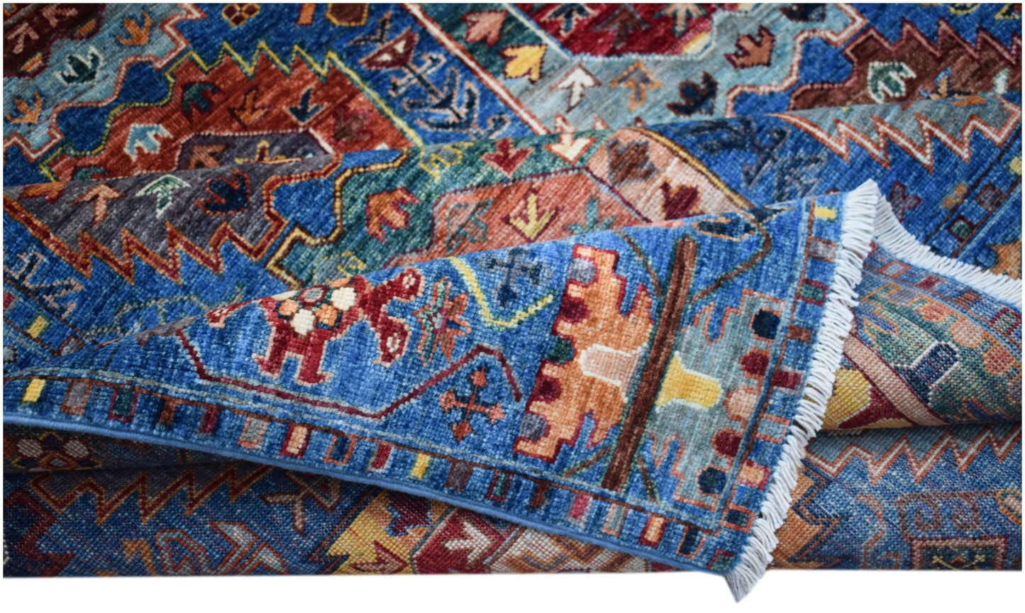A handwoven Afghan Chobi rug featuring intricate geometric patterns in blue, red, and gold tones.