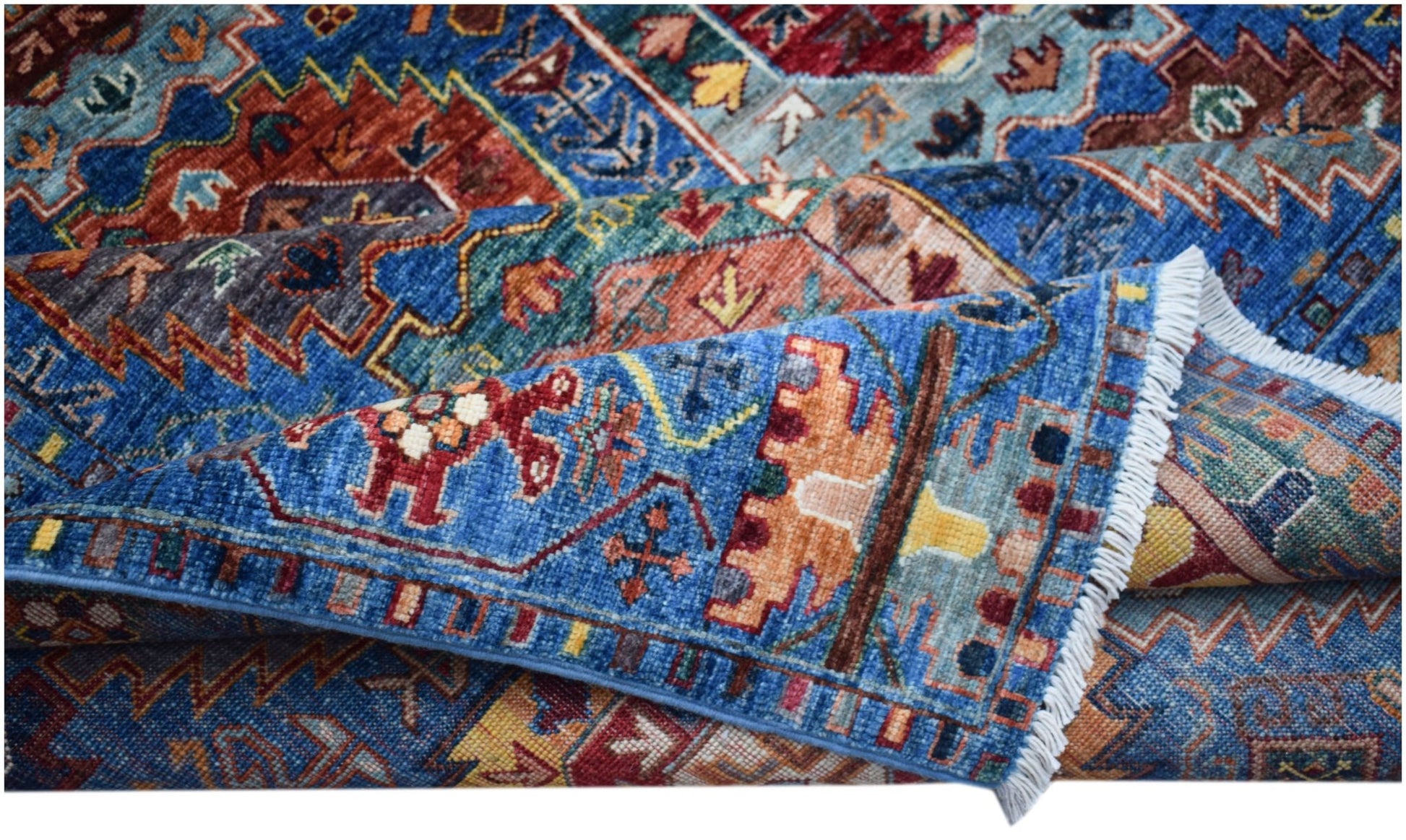 A handwoven Afghan Chobi rug featuring intricate geometric patterns in blue, red, and gold tones.