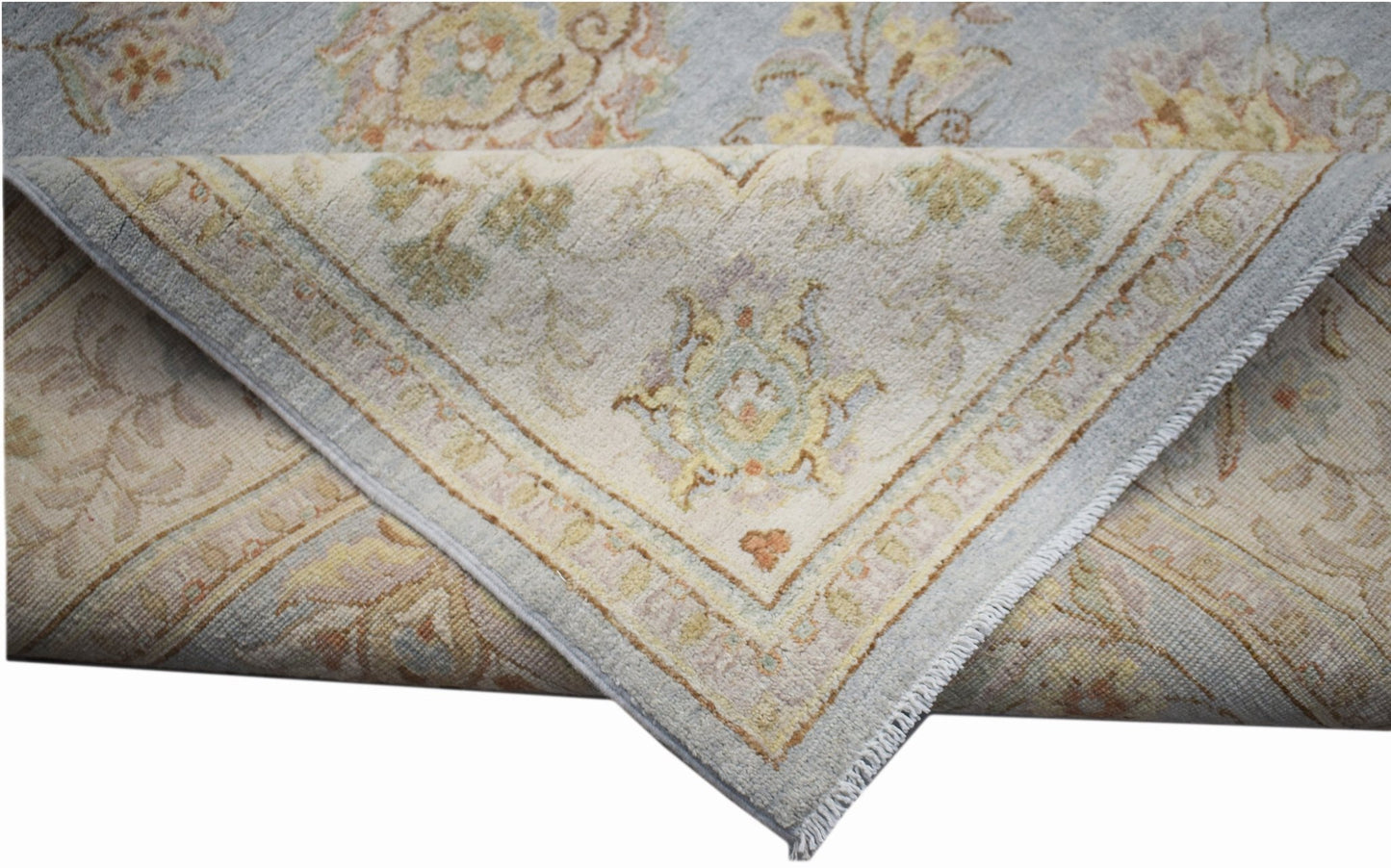 A handwoven Afghan Chobi rug featuring a light blue and cream floral pattern with a soft texture.