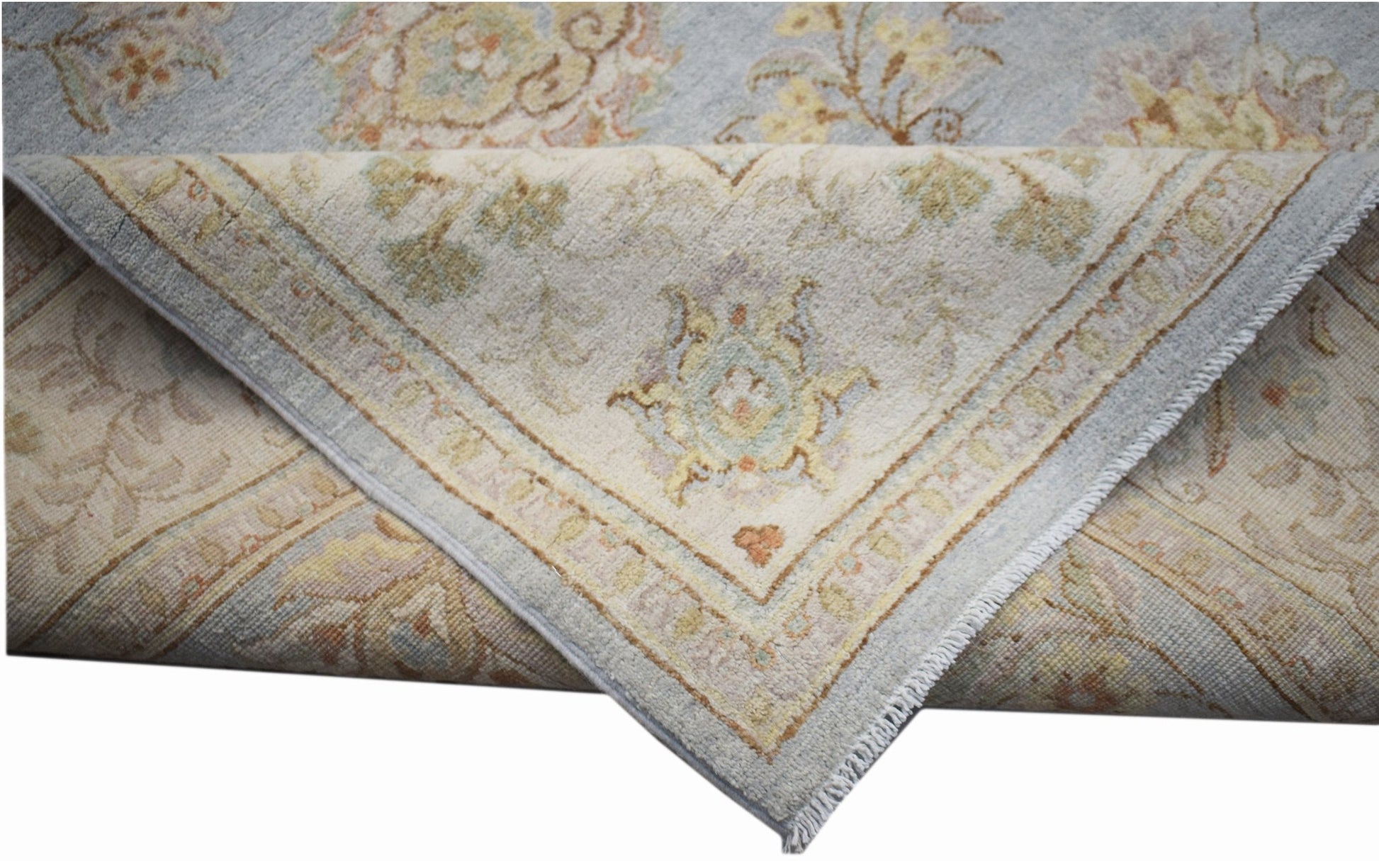 A handwoven Afghan Chobi rug featuring a light blue and cream floral pattern with a soft texture.