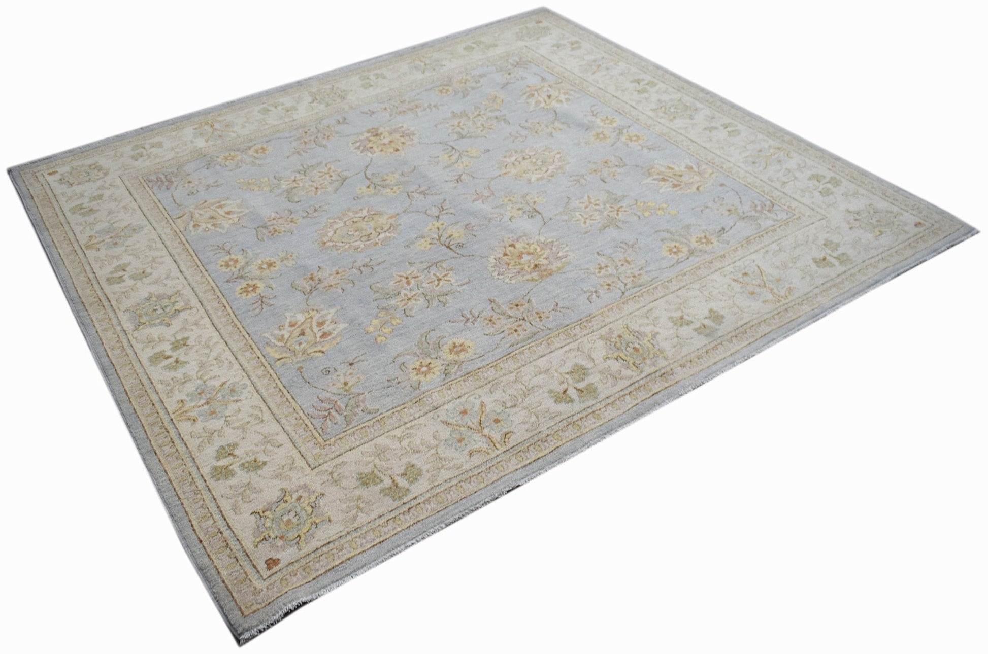 A rectangular Afghan Chobi rug featuring a light blue field with floral patterns and a beige border.