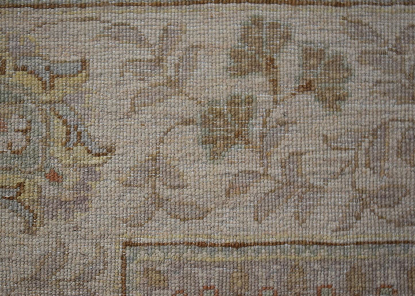 A close-up of an Afghan Chobi rug featuring intricate floral patterns in soft, earthy tones.