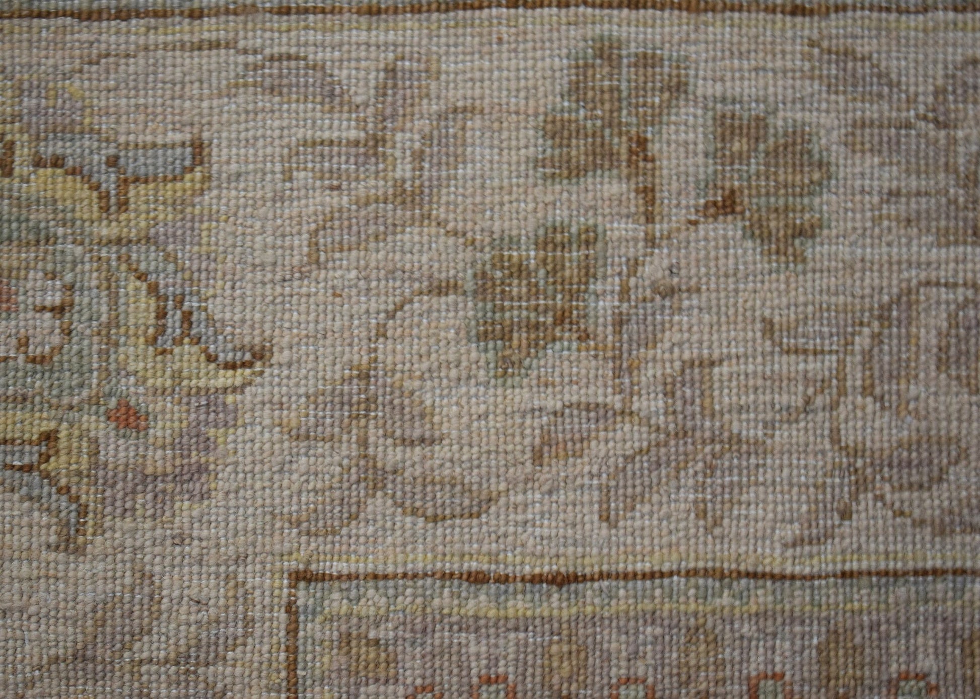 A close-up of an Afghan Chobi rug featuring intricate floral patterns in soft, earthy tones.