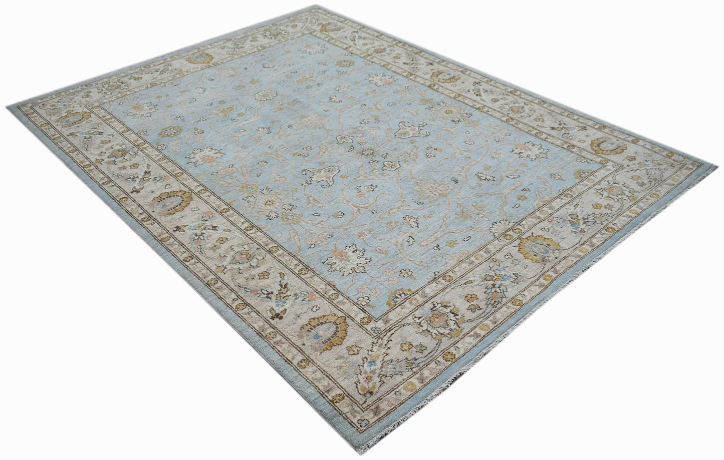 A rectangular Afghan Chobi rug featuring a light blue field with traditional floral patterns.
