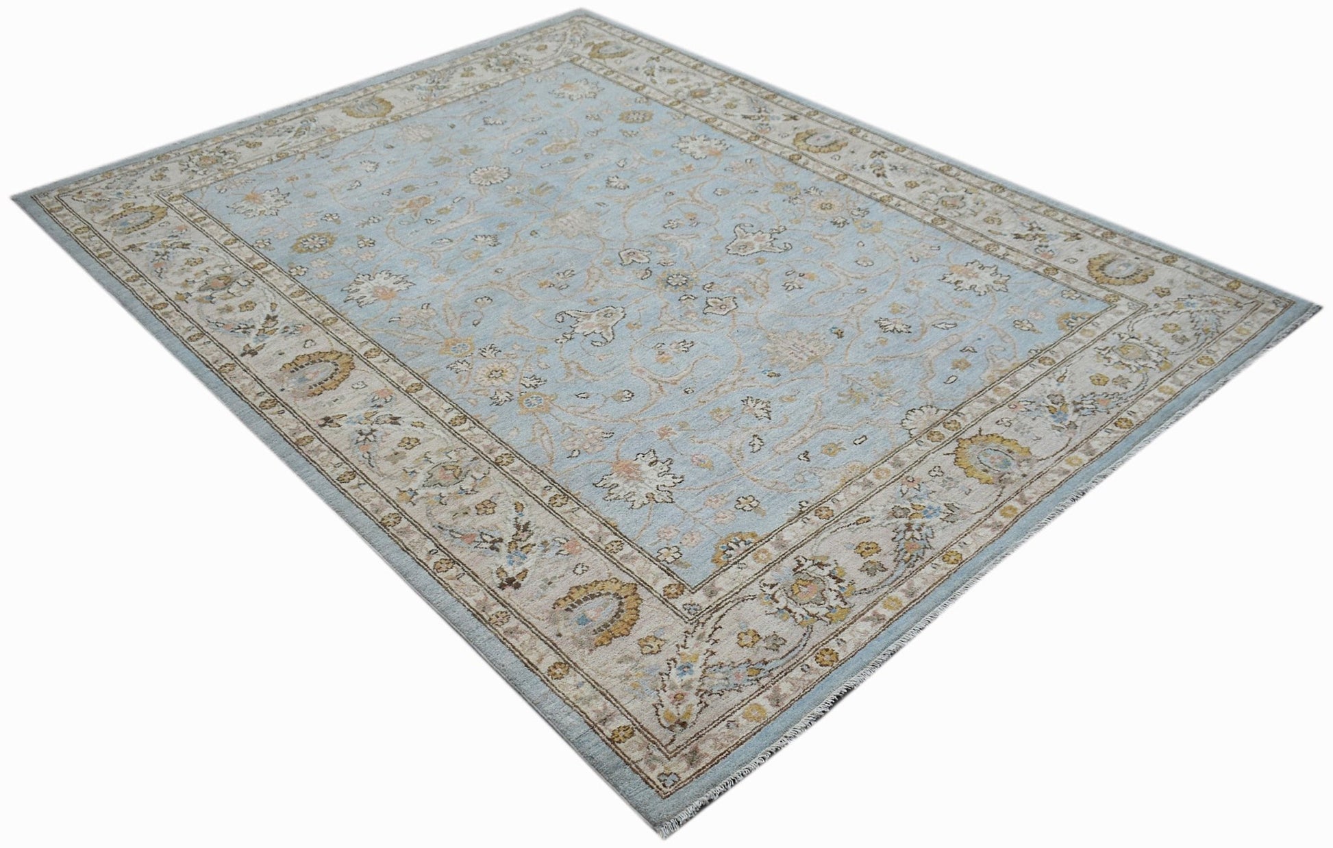 A rectangular Afghan Chobi rug featuring a light blue field with traditional floral patterns.