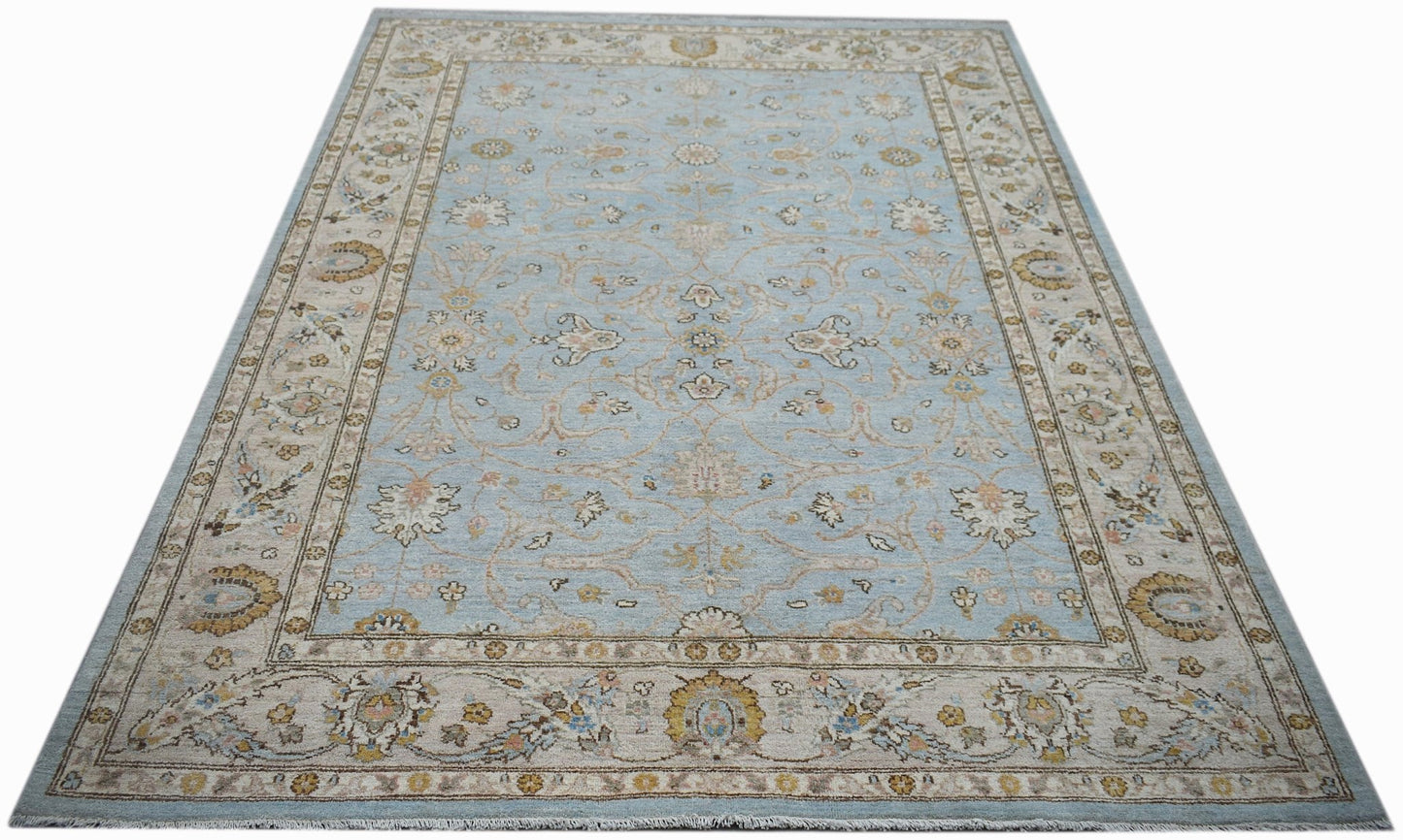 A rectangular Afghan Chobi rug featuring a light blue field with intricate floral patterns.