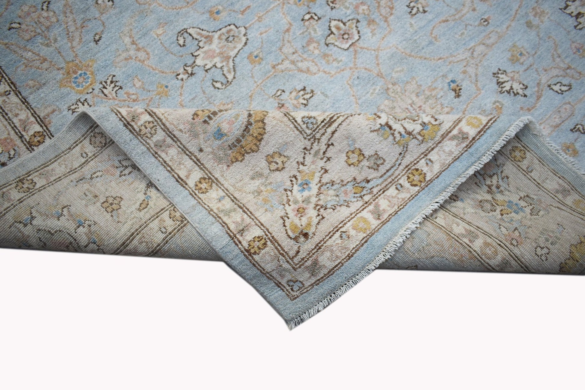 A handwoven Afghan Chobi rug featuring a light blue field with traditional floral patterns.