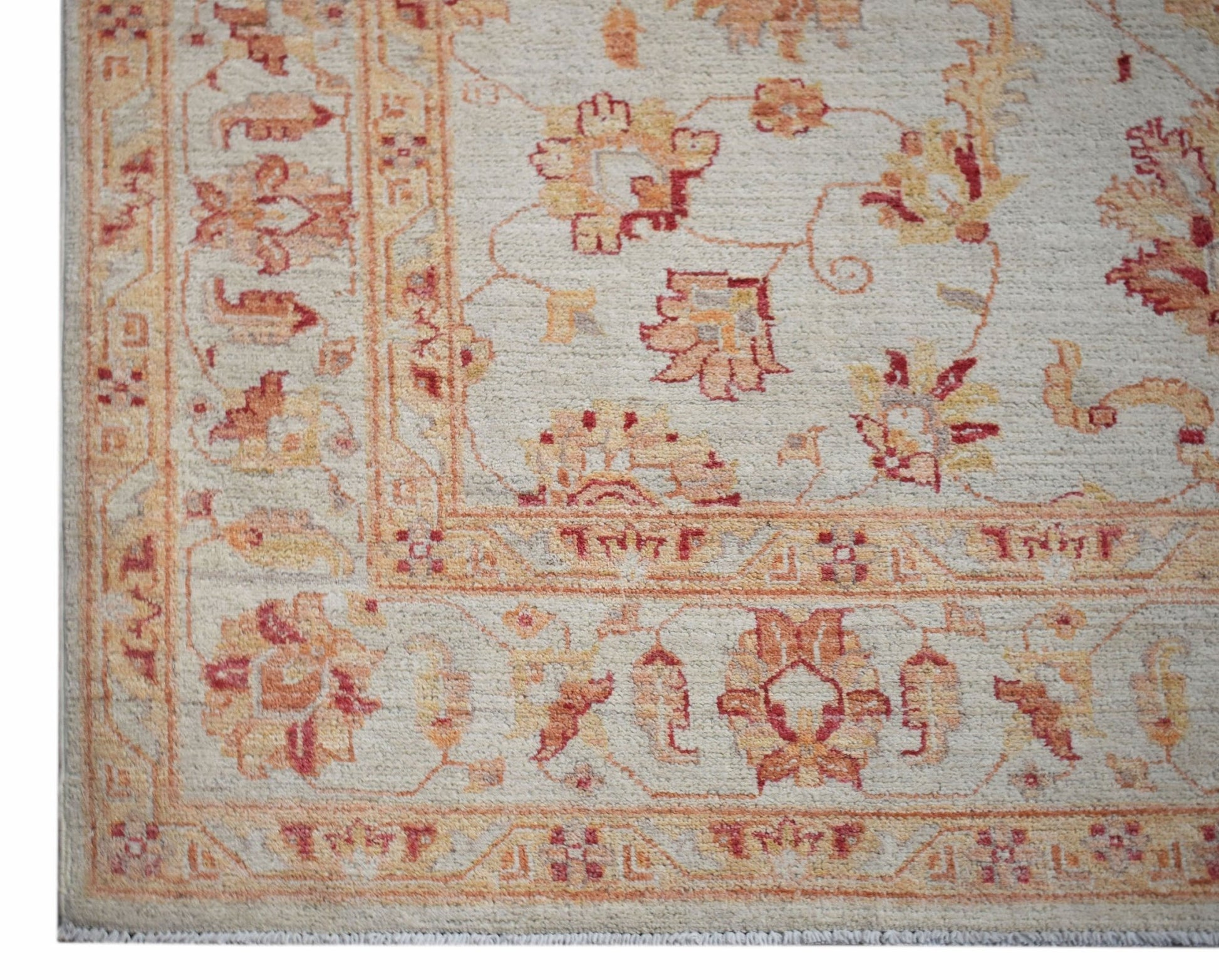 A handwoven Afghan Chobi rug featuring traditional floral patterns in warm wood-toned colors.