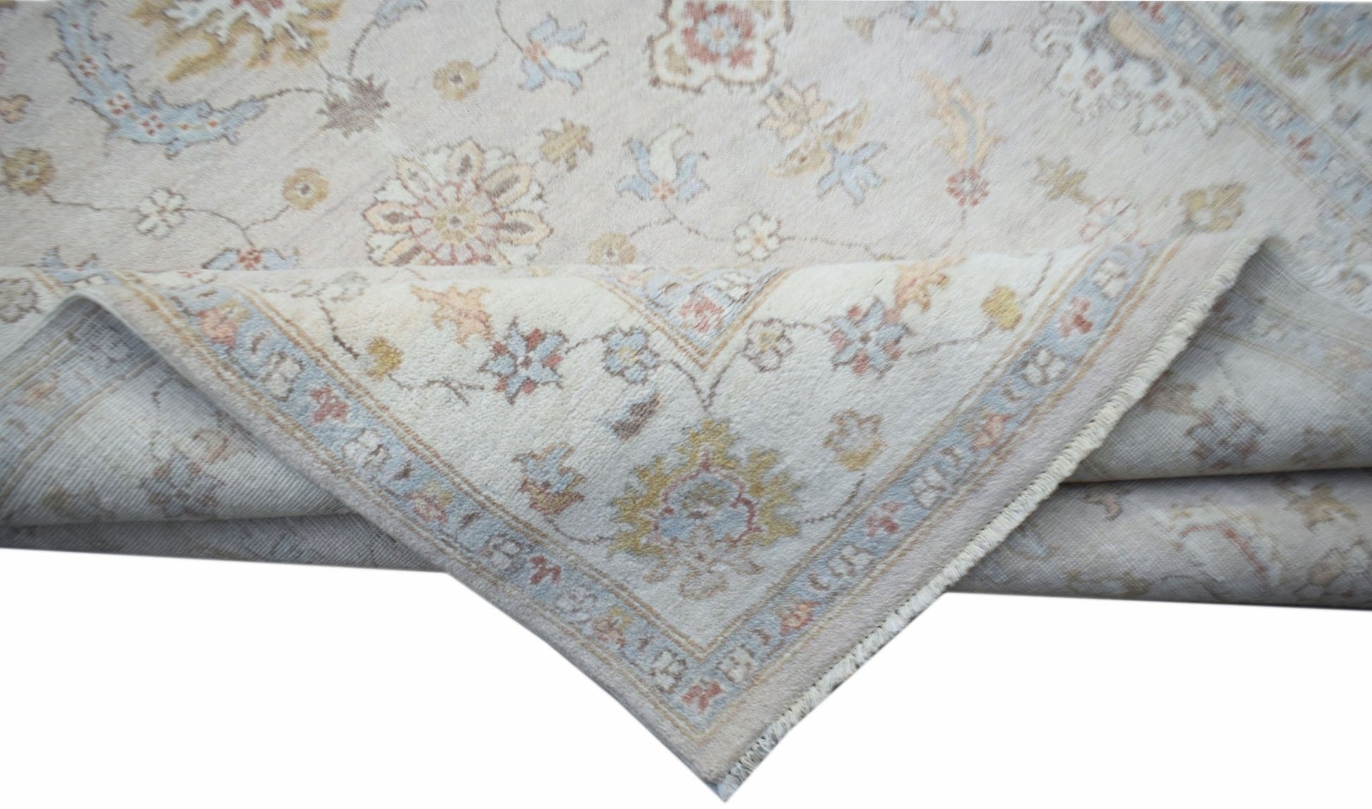 A handwoven Afghan Chobi rug featuring a traditional floral pattern in soft, muted earth tones.