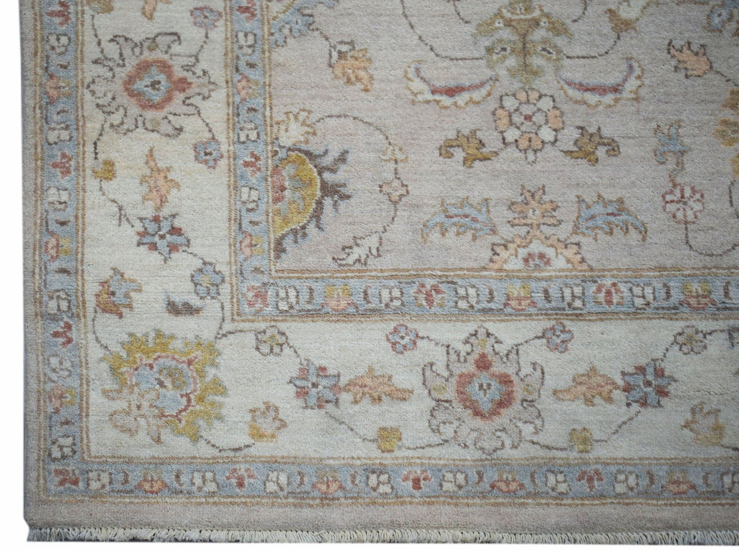 A handmade Afghan Chobi rug featuring a traditional floral pattern in soft, earthy tones.