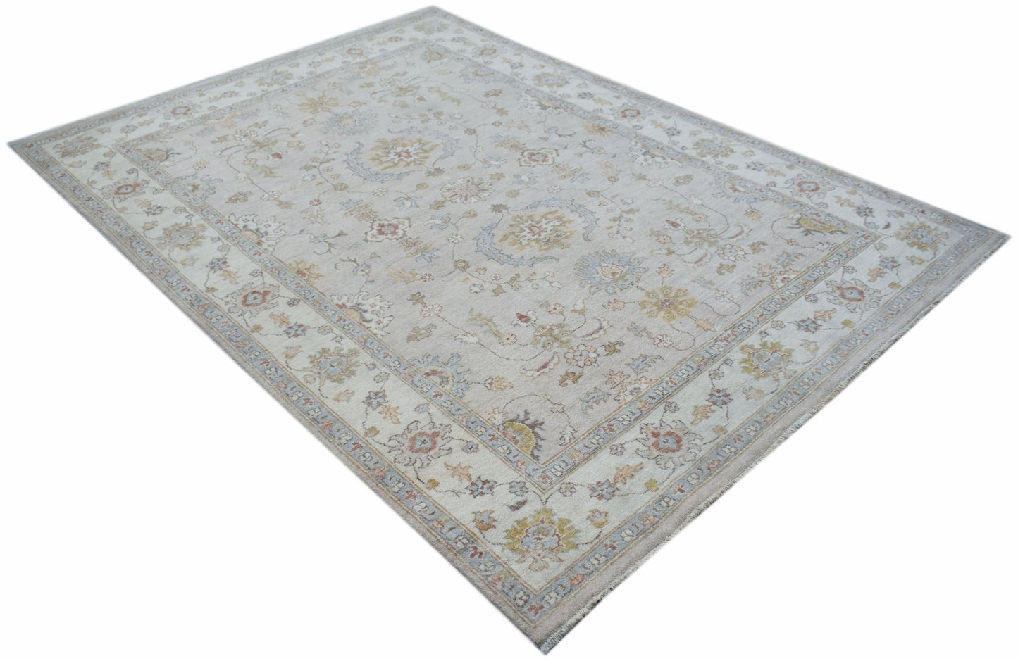 A rectangular Afghan Chobi rug featuring a traditional floral pattern in soft, muted earth tones.