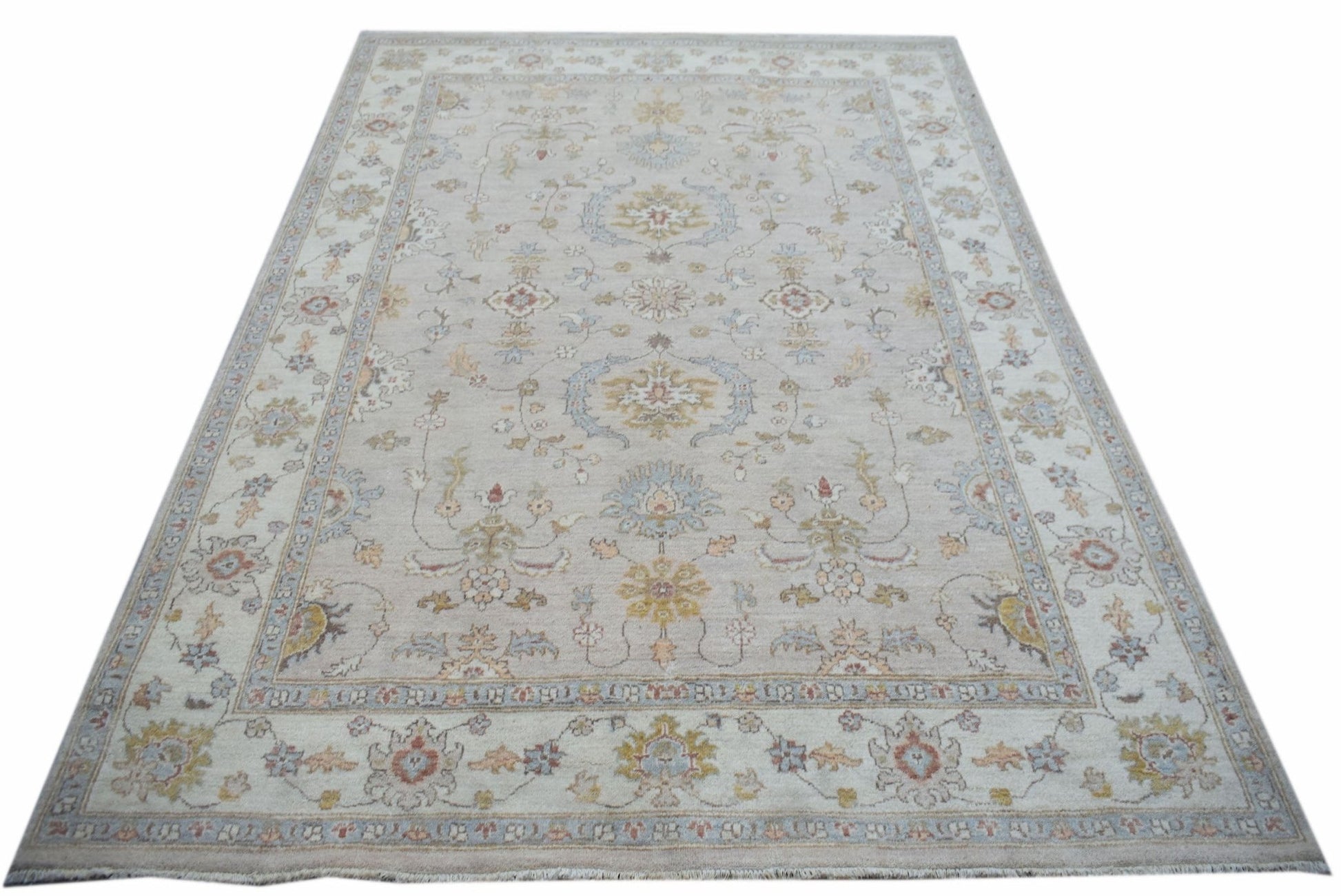 A rectangular Afghan Chobi rug featuring a traditional floral pattern in soft, earthy tones.