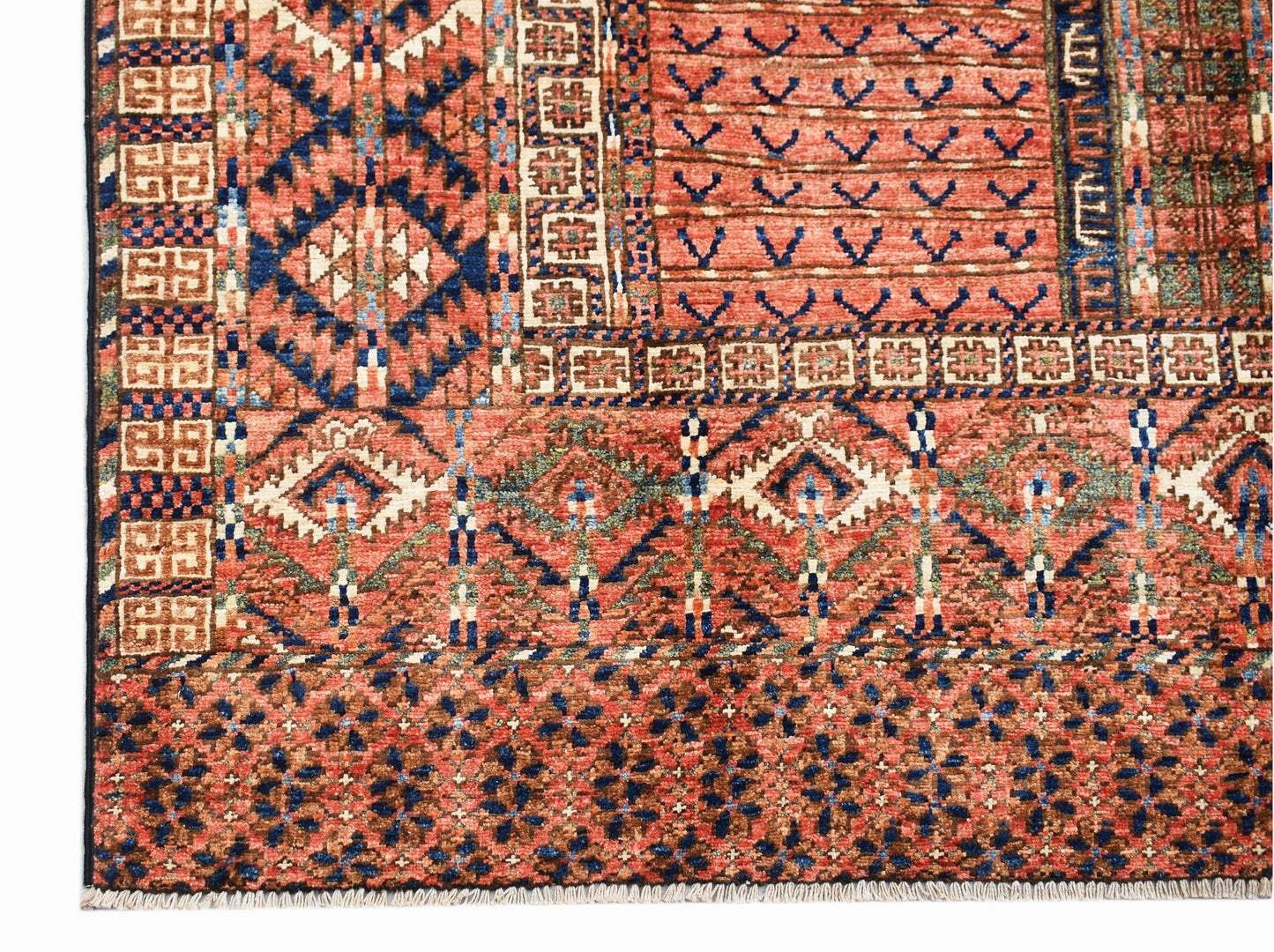 A handmade Afghan Chobi rug featuring intricate geometric patterns in warm earthy tones.