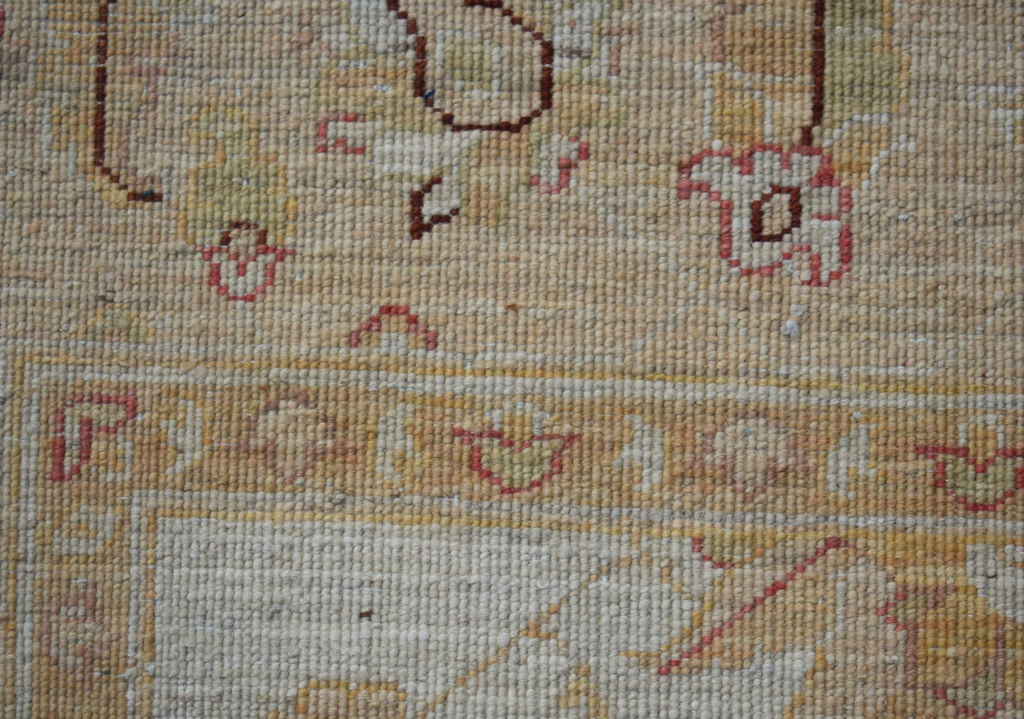 A close-up view of a handwoven Afghan Chobi rug featuring traditional patterns in earthy tones.