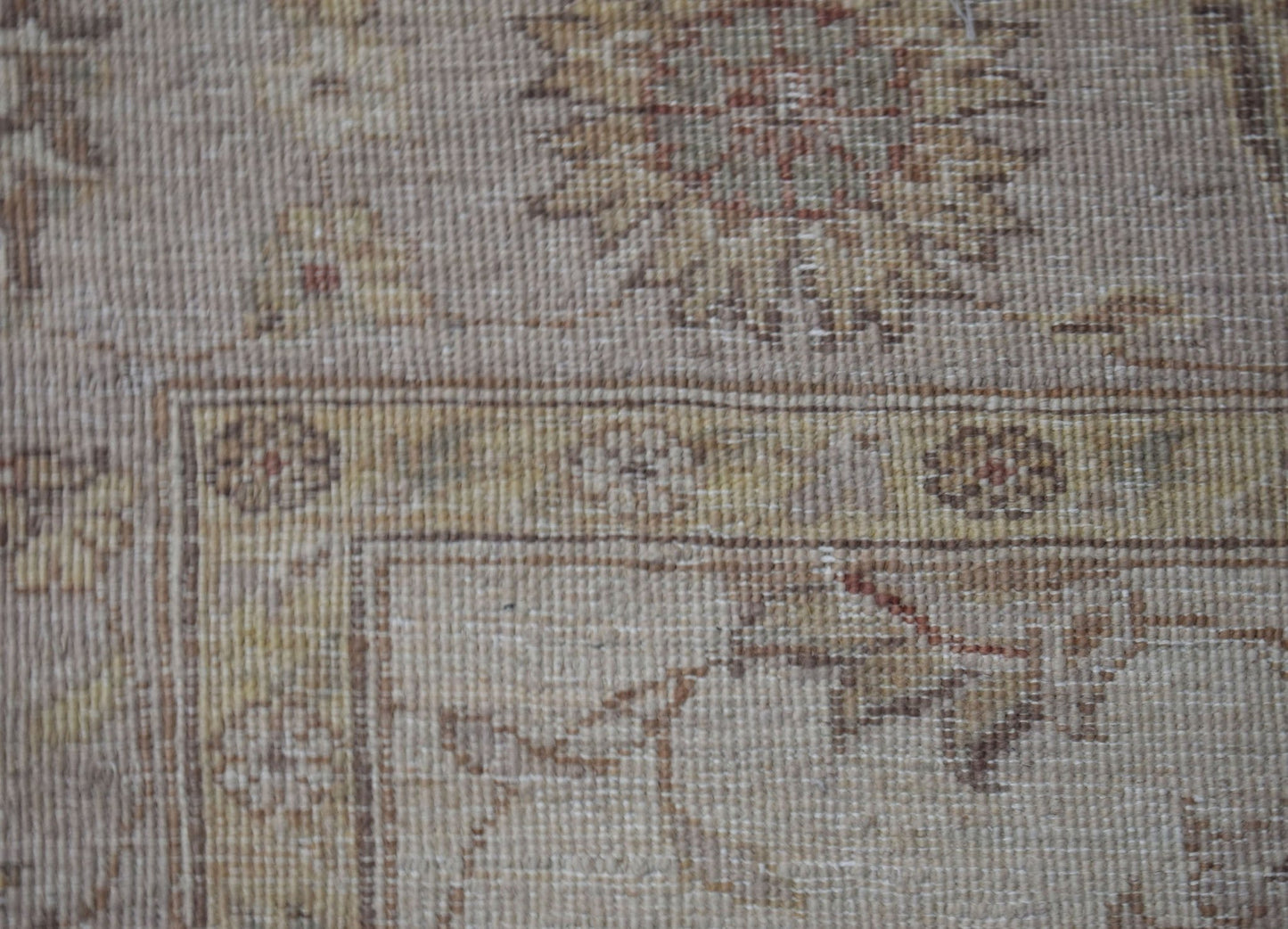 A close-up of a handwoven Afghan Chobi rug featuring traditional floral patterns in earthy tones.