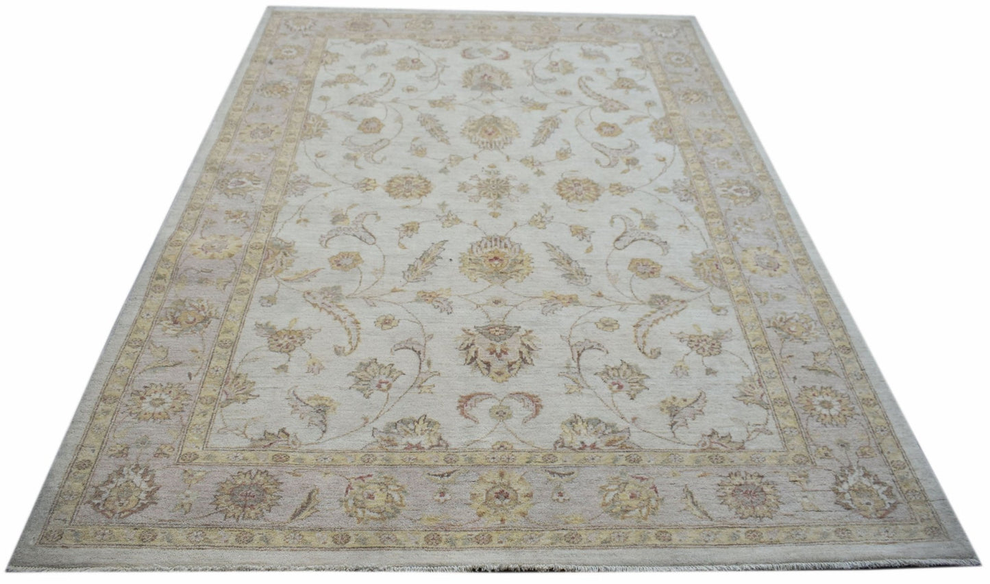 An Afghan Chobi rug featuring a traditional floral pattern in soft beige and muted earth tones.