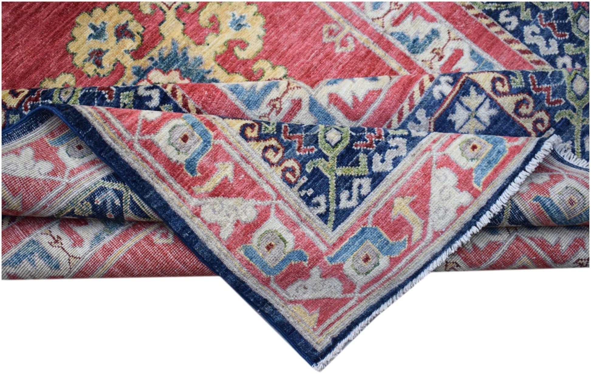 A handwoven Afghan Chobi rug featuring traditional geometric patterns in red, blue, and yellow.
