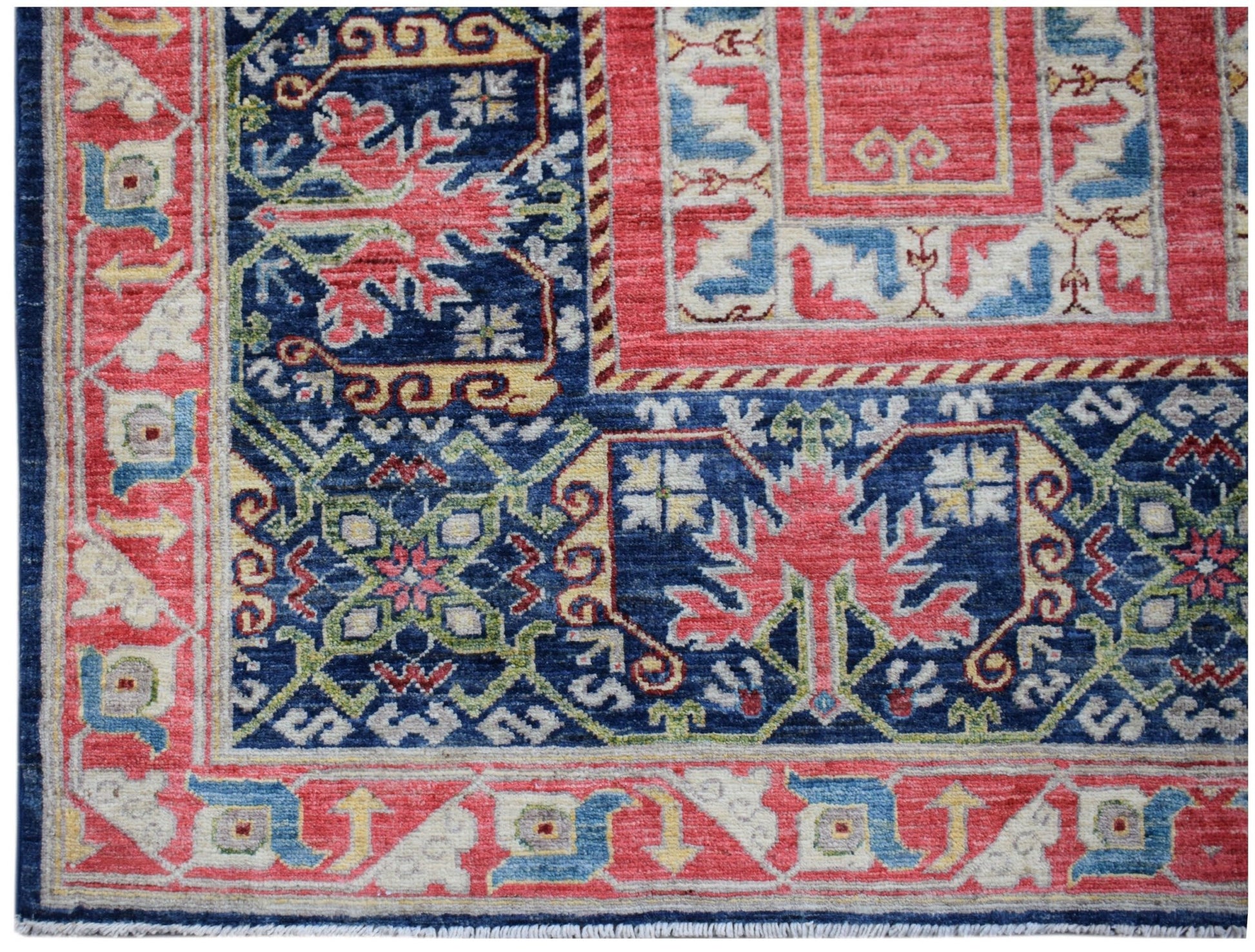 A handwoven Afghan Chobi rug featuring a traditional geometric pattern in red, blue, and cream.