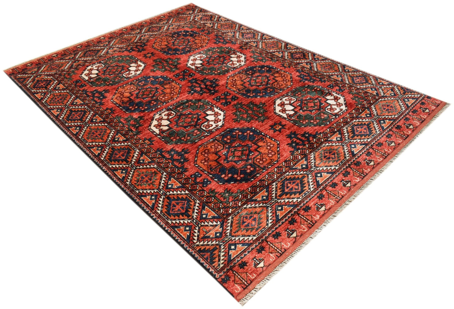 A rectangular Afghan Chobi rug featuring a traditional geometric pattern in red, blue, and cream.