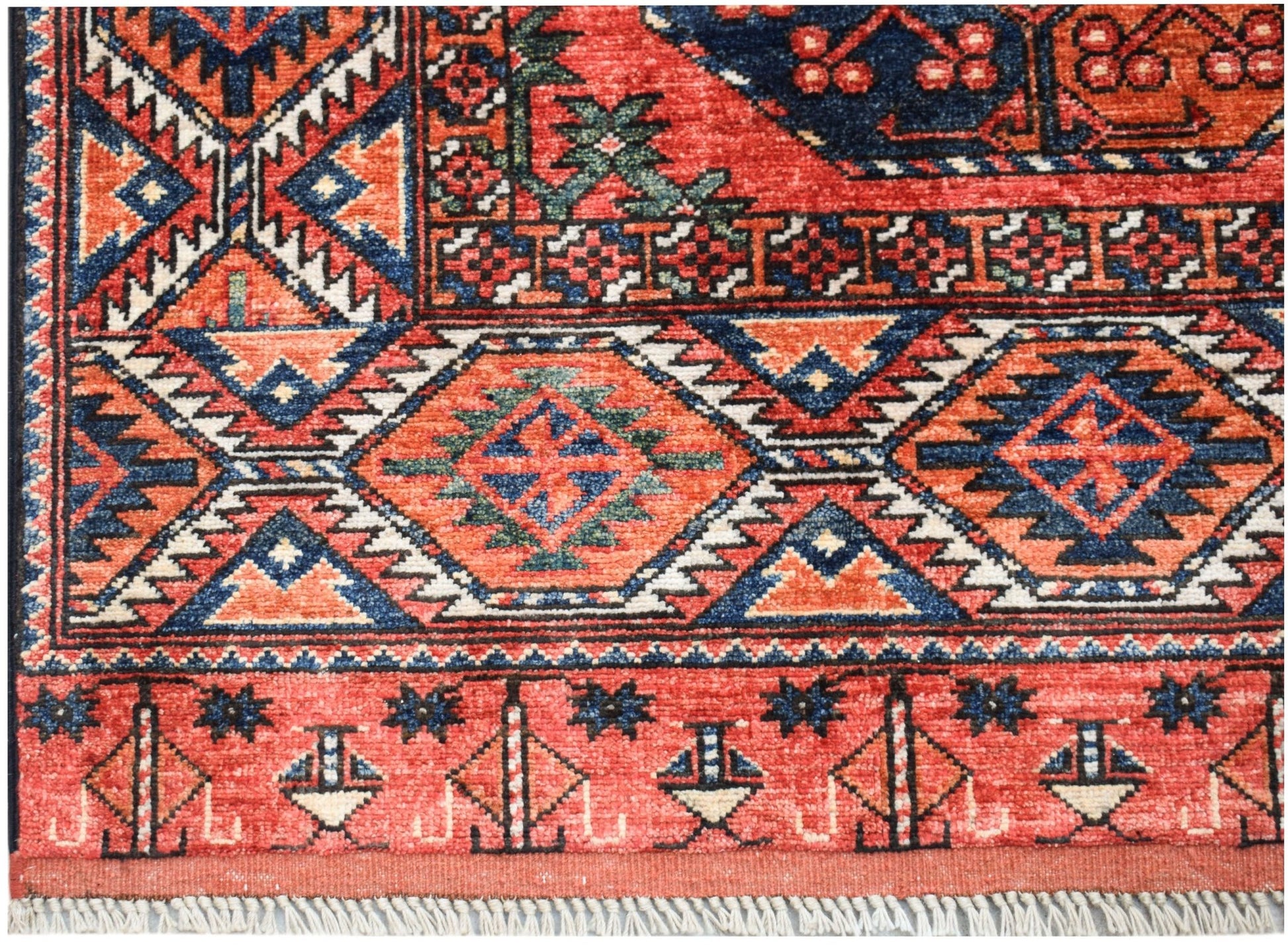 A handwoven Afghan Chobi rug featuring traditional geometric patterns in red, blue, and cream.