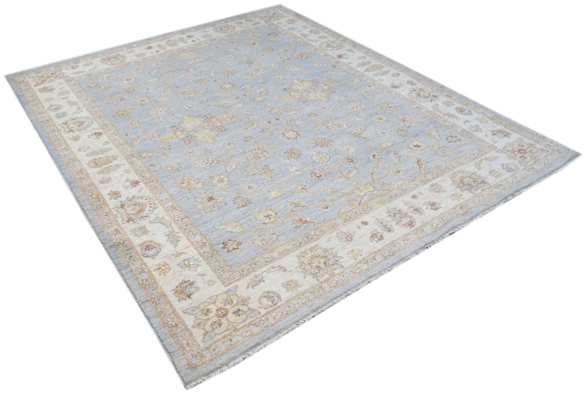 A rectangular Afghan Chobi rug featuring a light blue field with floral patterns and a cream border.