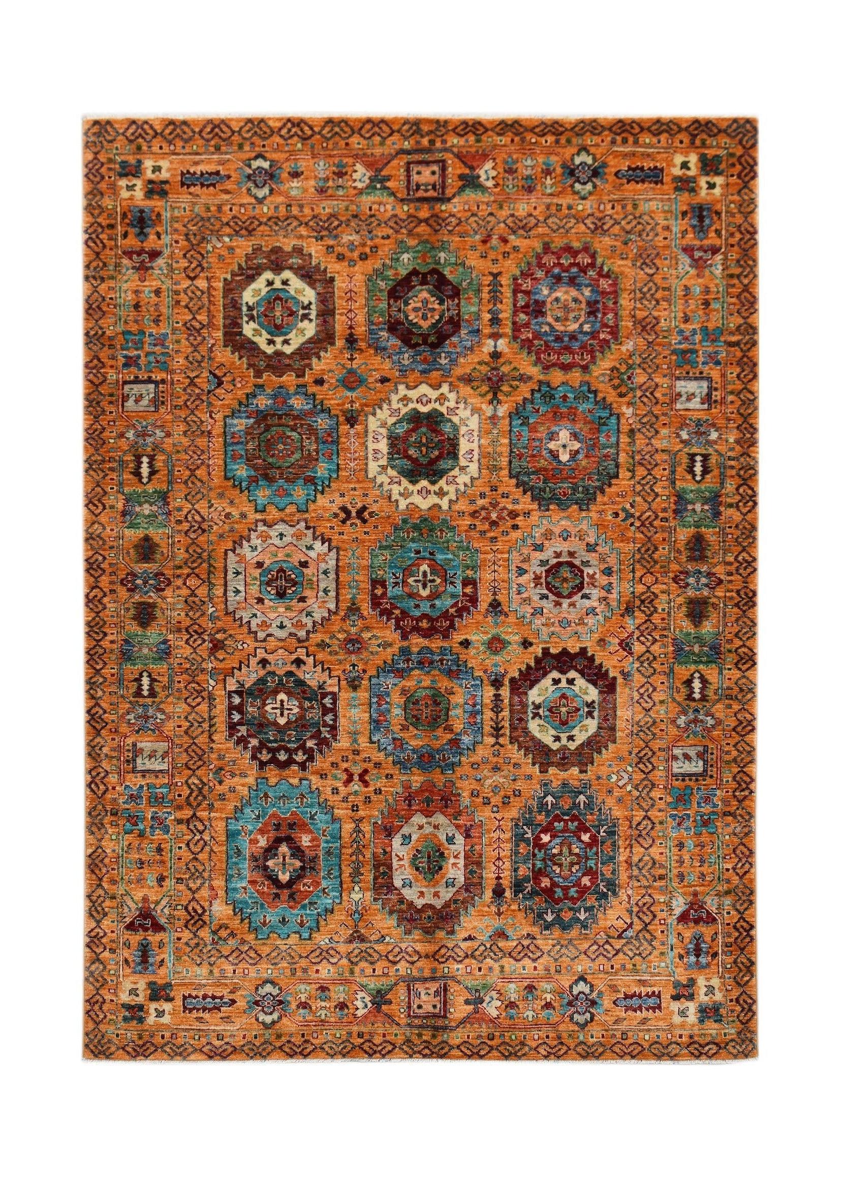 Handwoven Afghan Chobi rug featuring a geometric medallion pattern in warm, earthy tones.