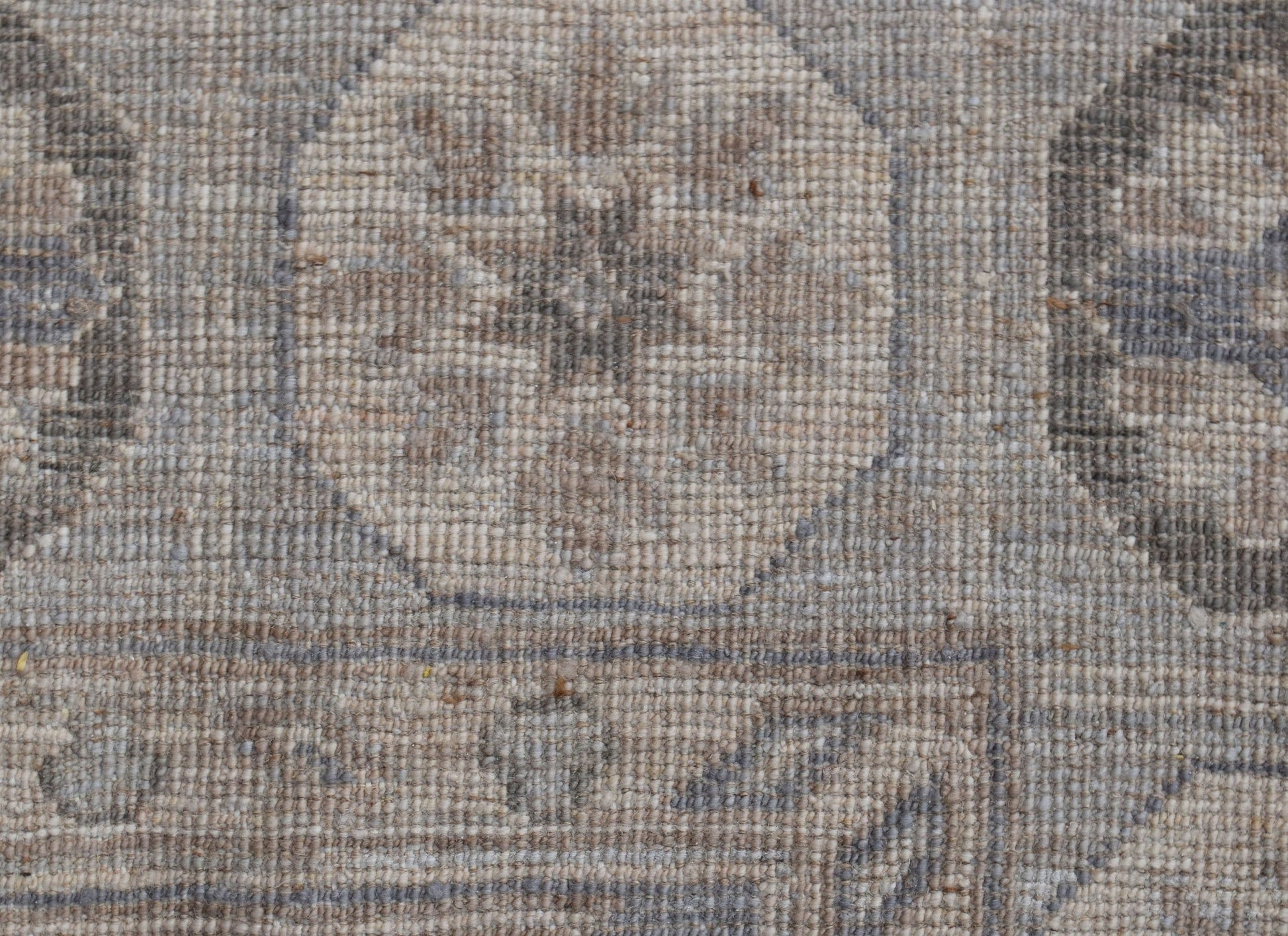 A close-up of a handwoven Afghan Chobi rug featuring a traditional geometric pattern in neutral tones.