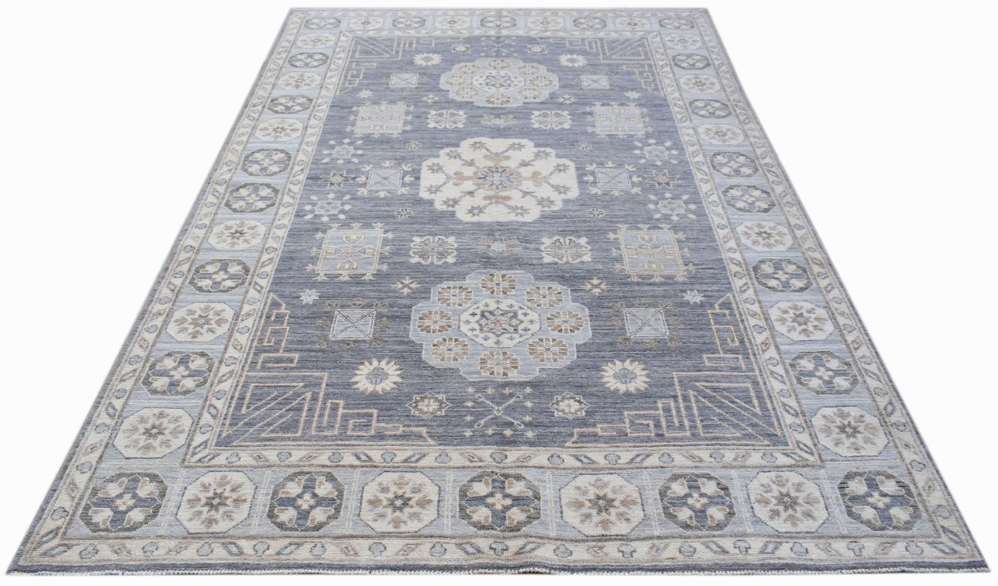 A rectangular Afghan Chobi rug featuring a traditional floral pattern in shades of blue and beige.