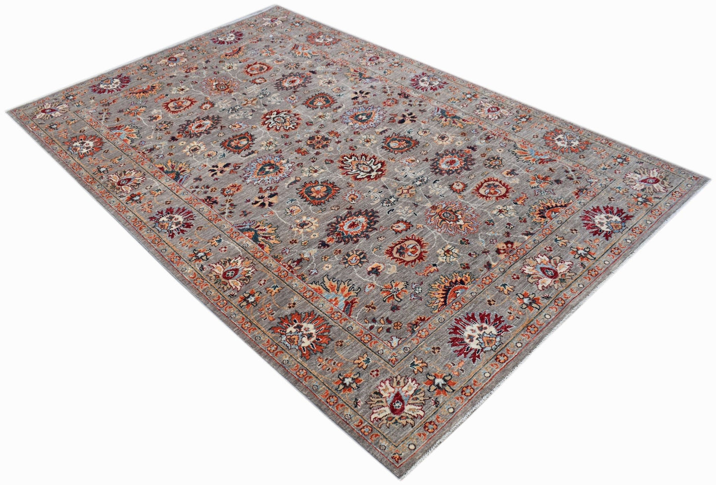 A rectangular Afghan Chobi rug featuring a traditional floral pattern in muted earth tones.