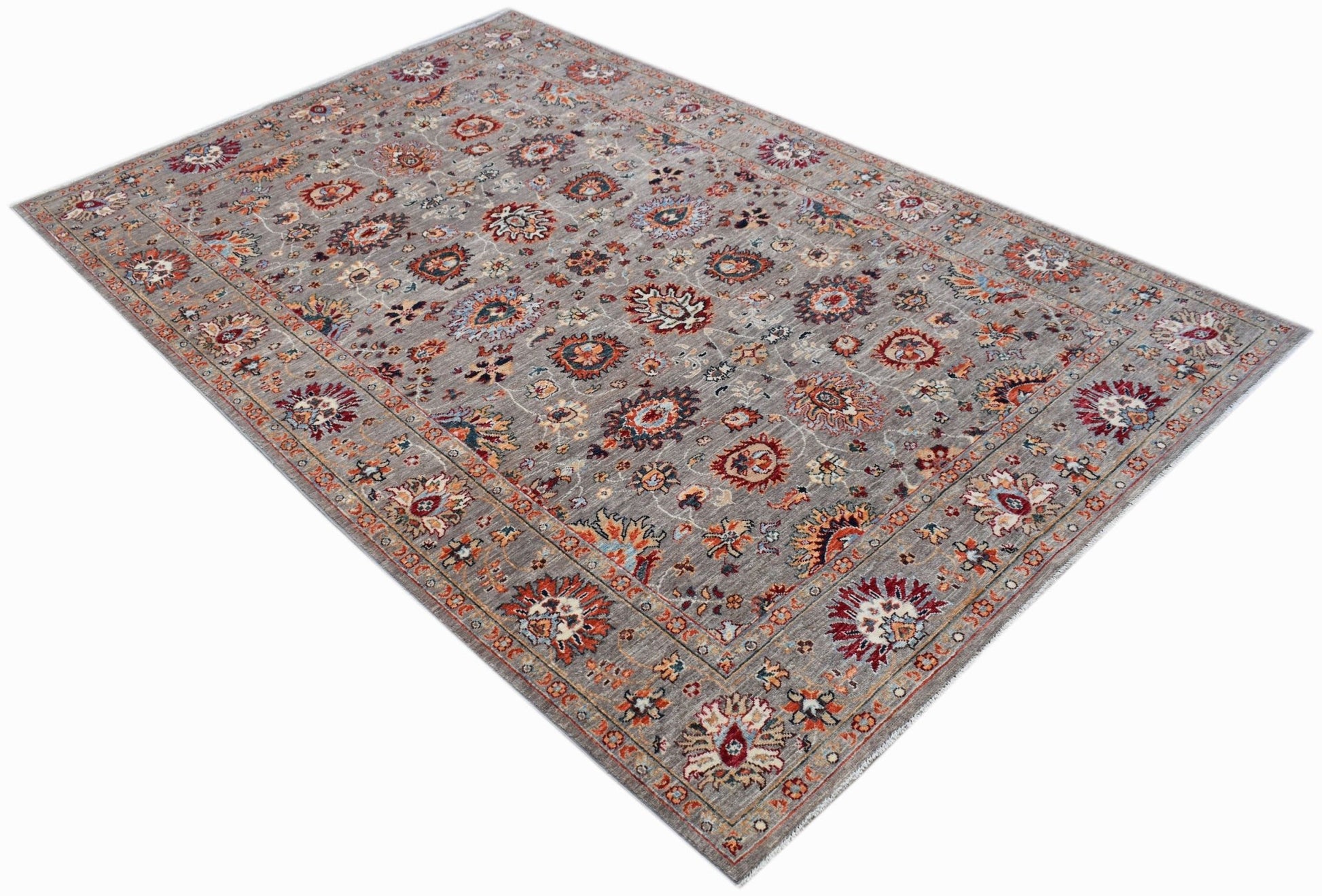 A rectangular Afghan Chobi rug featuring a traditional floral pattern in muted earth tones.
