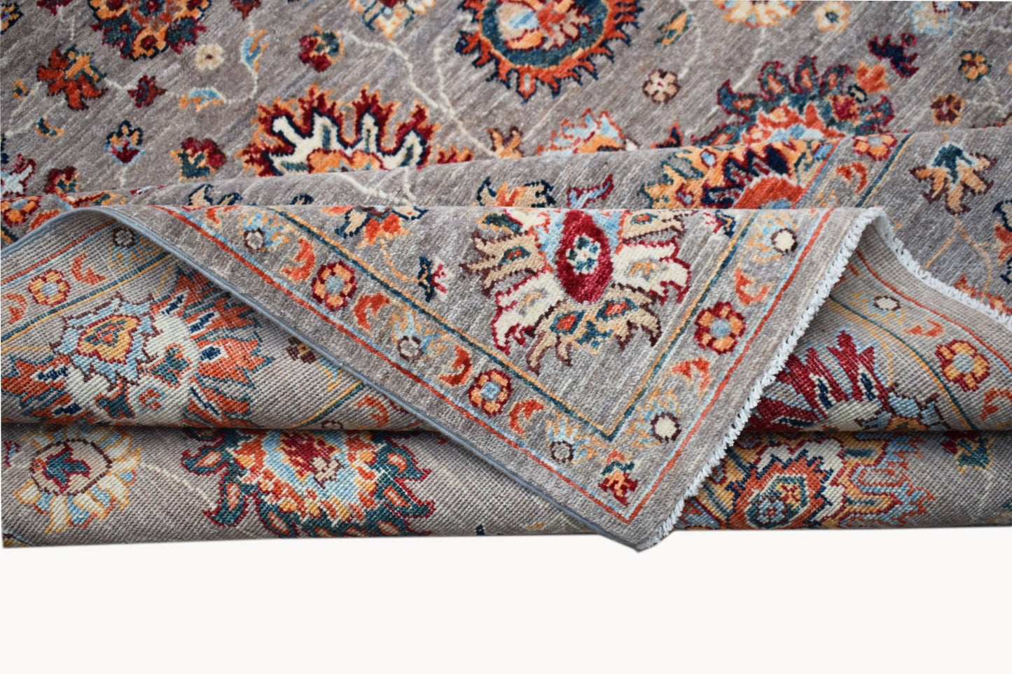 A handwoven Afghan Chobi rug featuring a traditional floral pattern in warm, earthy tones.