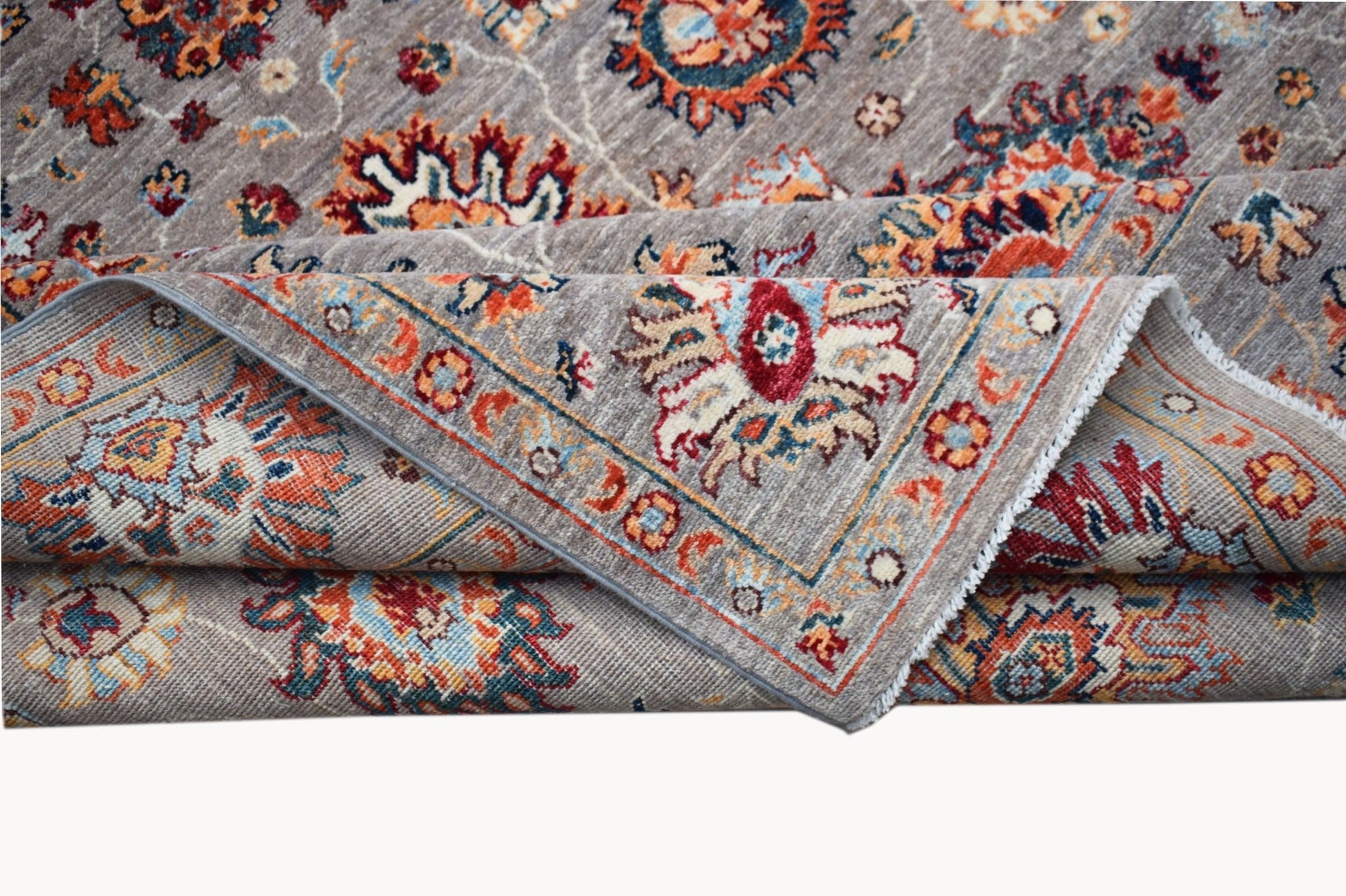 A handwoven Afghan Chobi rug featuring a traditional floral pattern in warm, earthy tones.