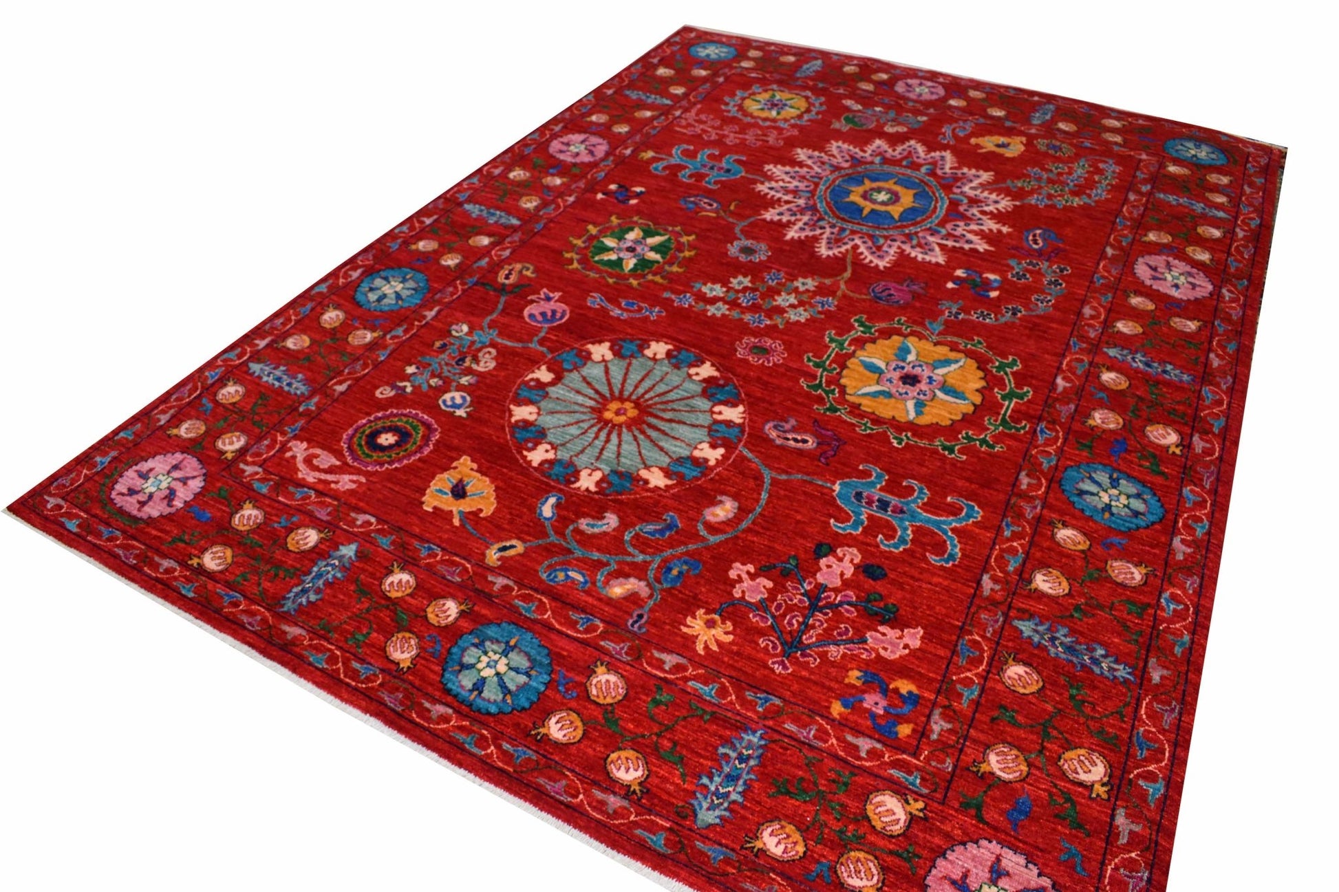 A rectangular Afghan Chobi rug featuring intricate floral and geometric patterns on a red background.
