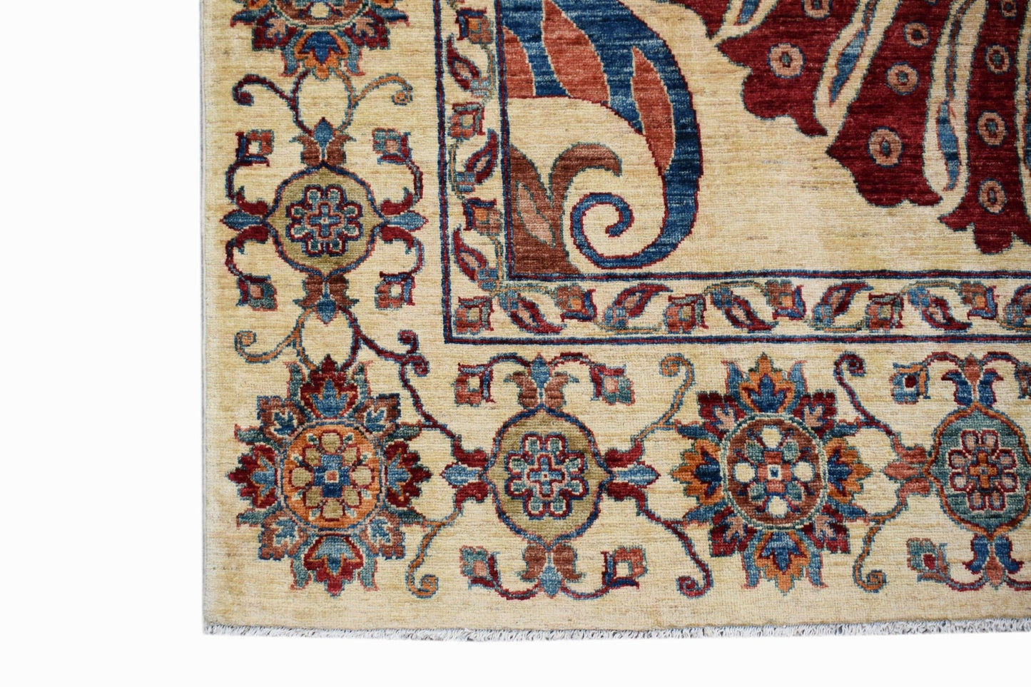 A corner view of a handwoven Afghan Chobi rug featuring traditional floral patterns in warm tones.