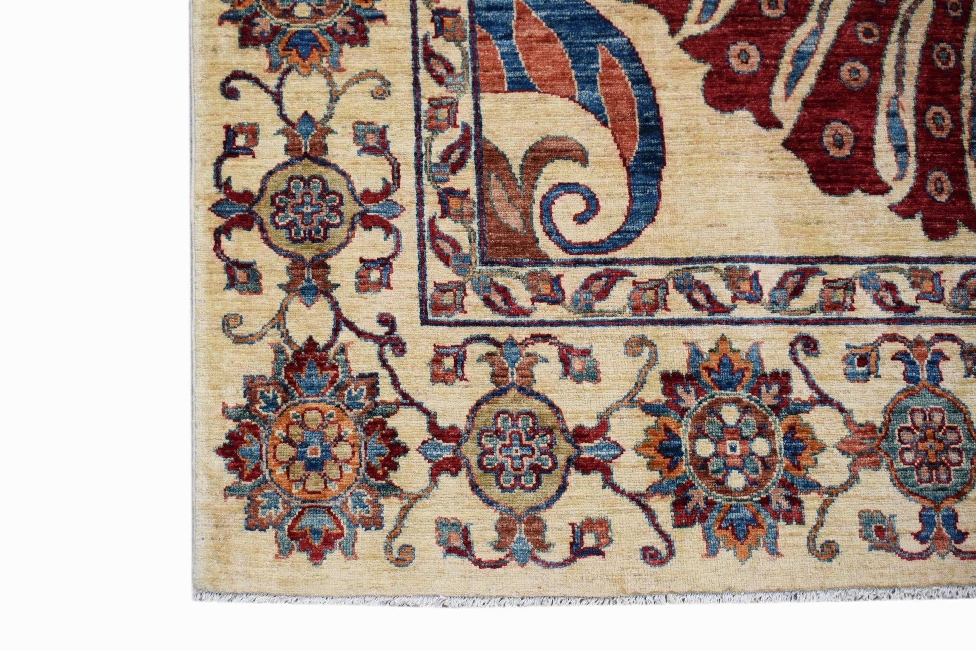 A corner view of a handwoven Afghan Chobi rug featuring traditional floral patterns in warm tones.