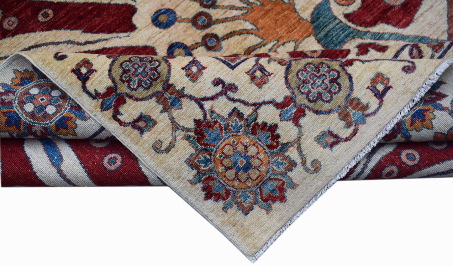 A handwoven Afghan Chobi rug featuring intricate floral patterns in red, blue, and earthy tones.