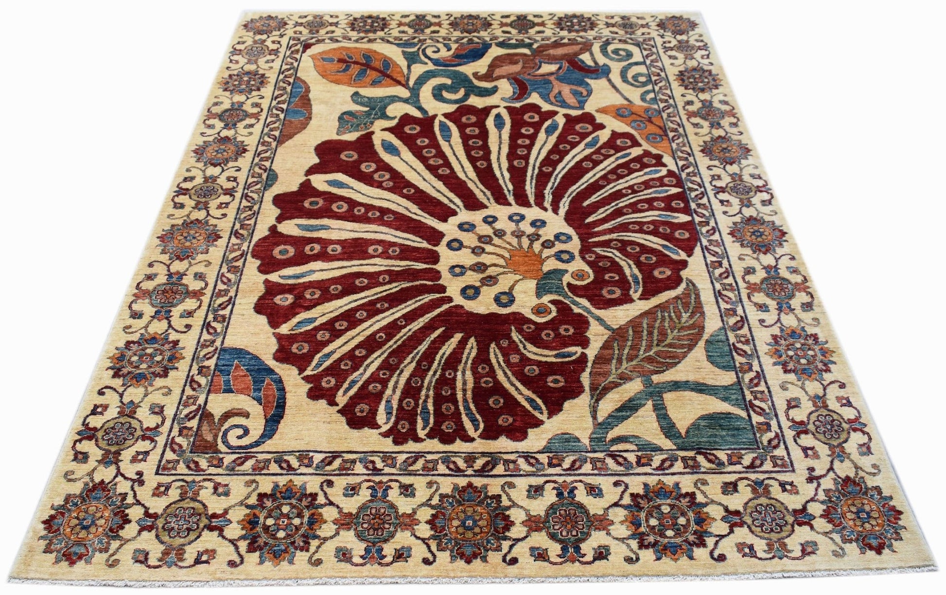 An Afghan Chobi rug featuring a large central floral motif in deep red on a cream background.