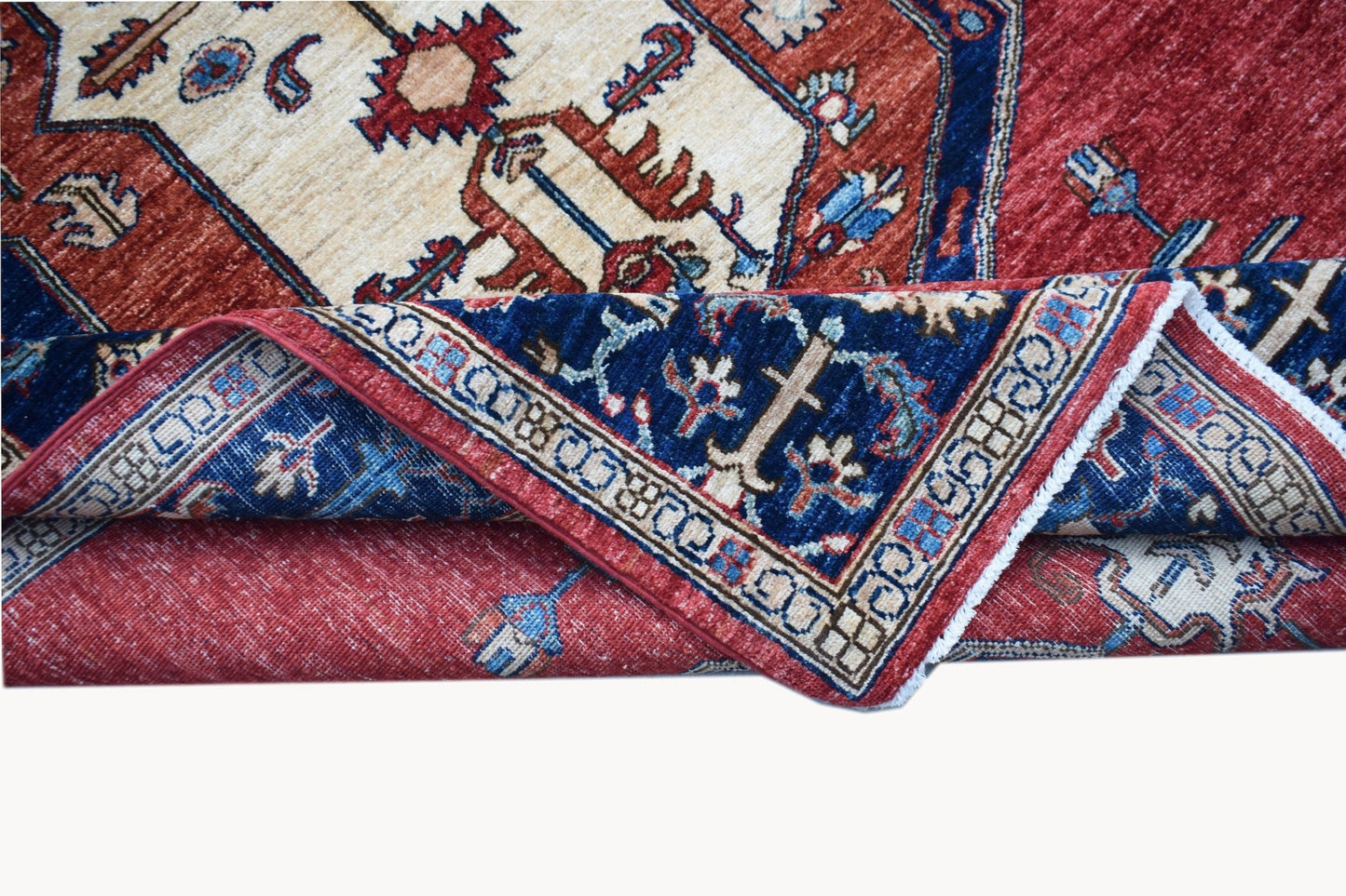 A handwoven Afghan Chobi rug featuring a traditional geometric pattern in red, blue, and cream.