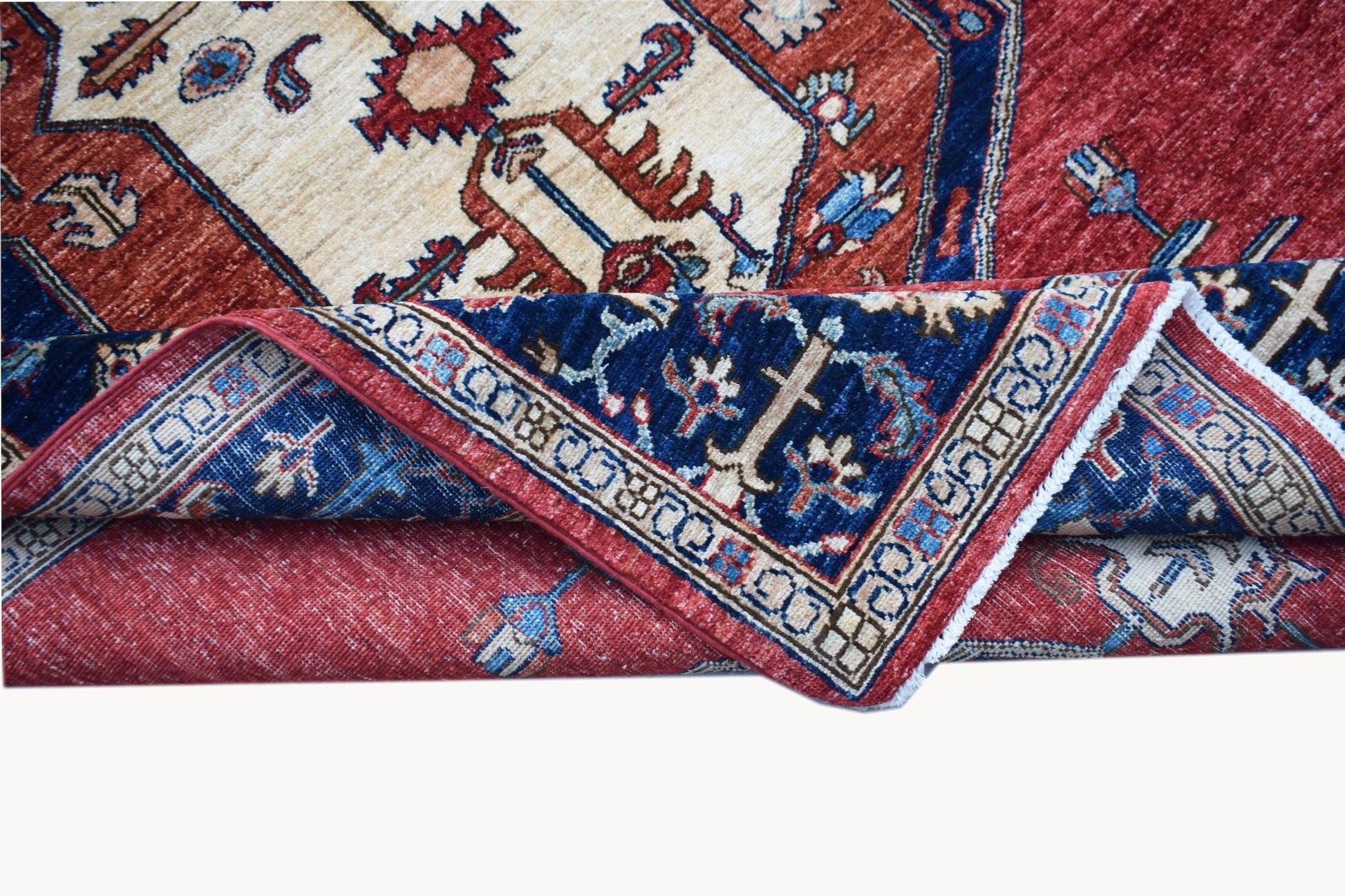 A handwoven Afghan Chobi rug featuring a traditional geometric pattern in red, blue, and cream.